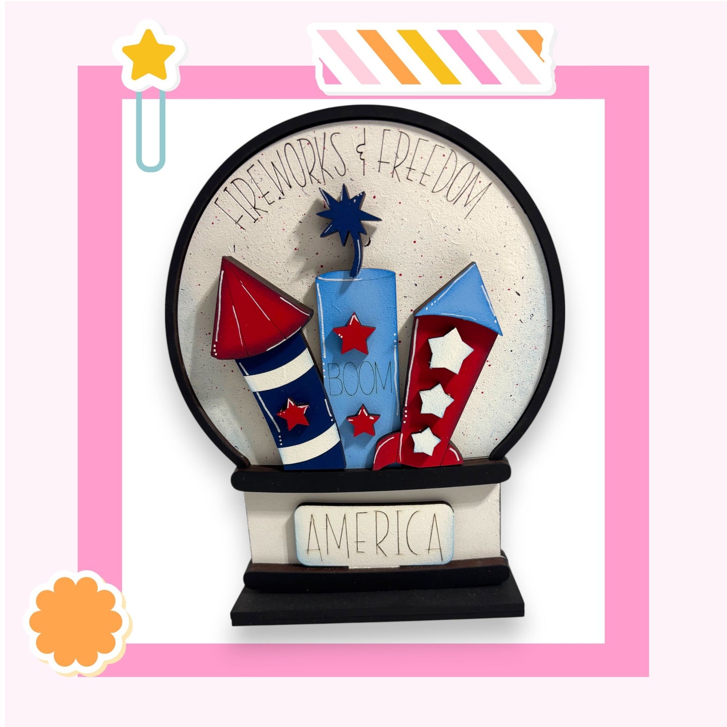 A colorful and whimsical representation of fireworks and the word "AMERICA" in a decorative frame.