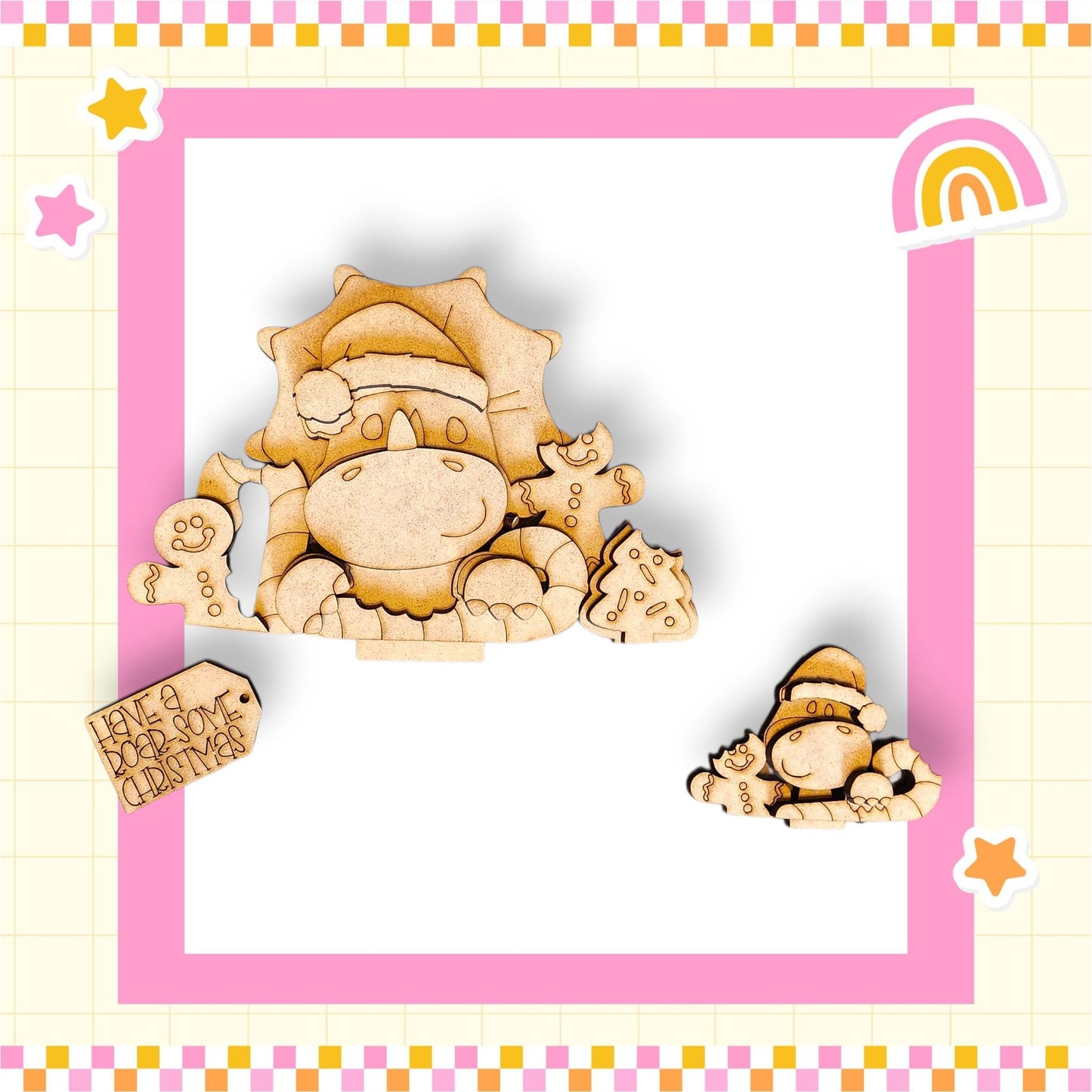 a wooden cutout of a dinosaur wearing a Santa hat, surrounded by other wooden cutouts and a pink and white checkered border.