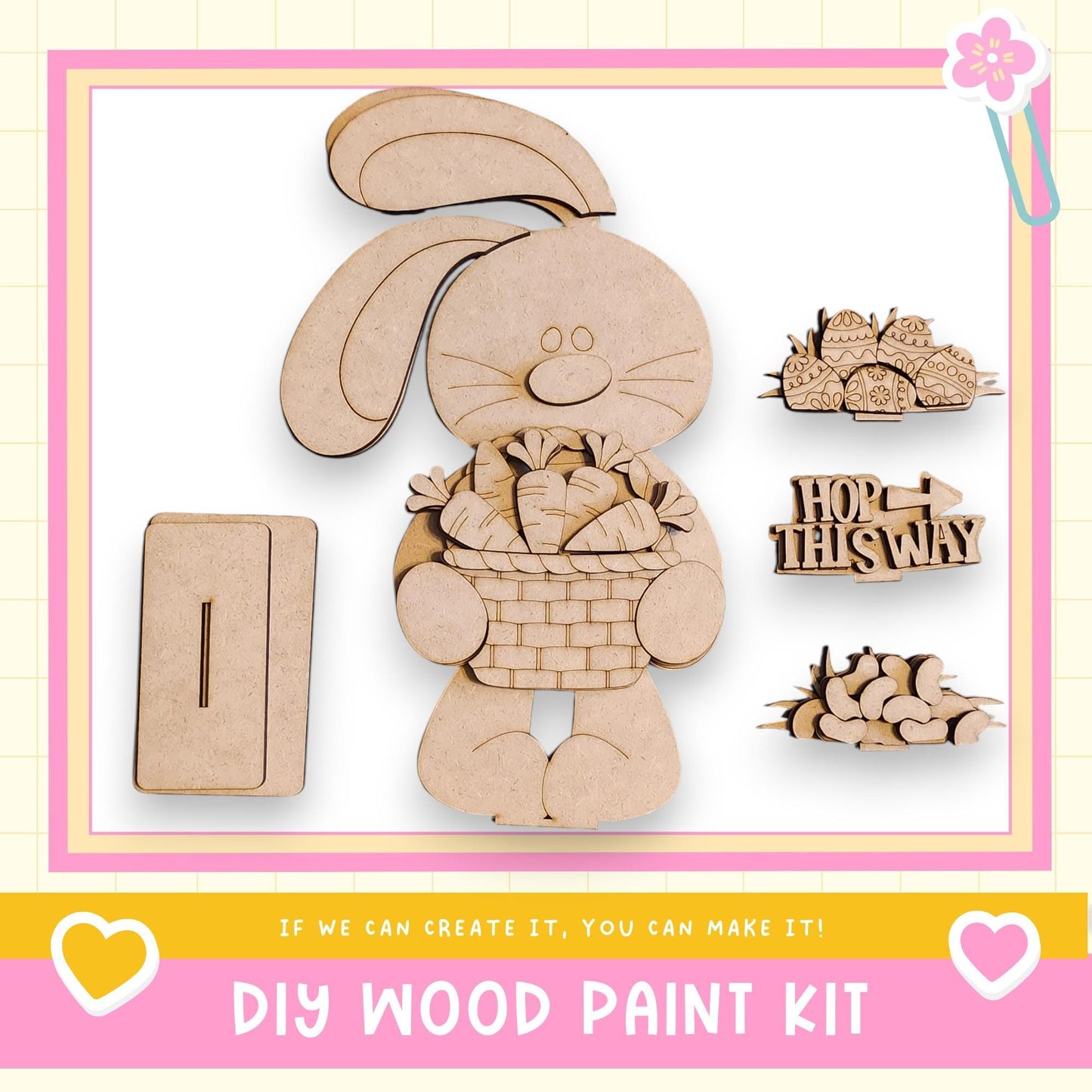 The image is a DIY wood paint kit featuring a wooden rabbit holding a basket of carrots, along with various other wooden shapes and a sign that says "HOP THIS WAY".