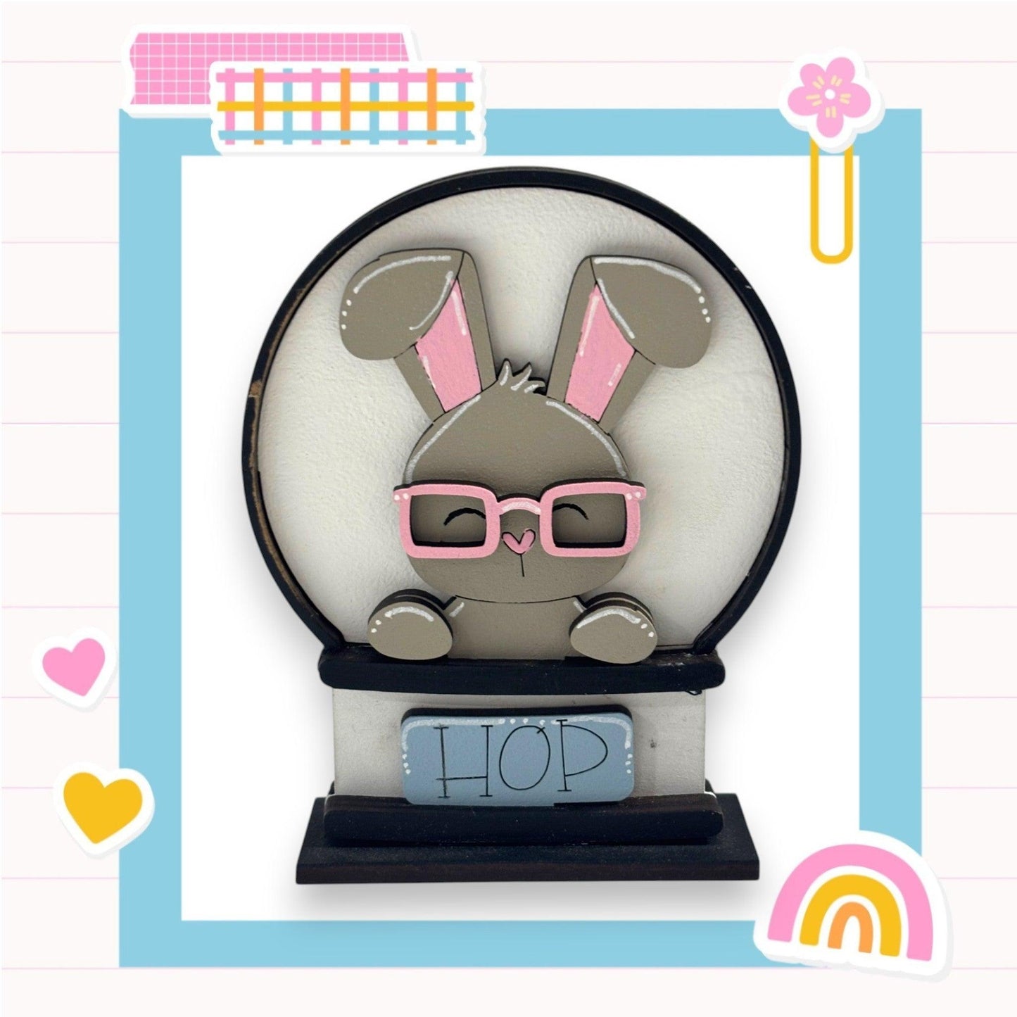 a paper cut of a bunny wearing glasses