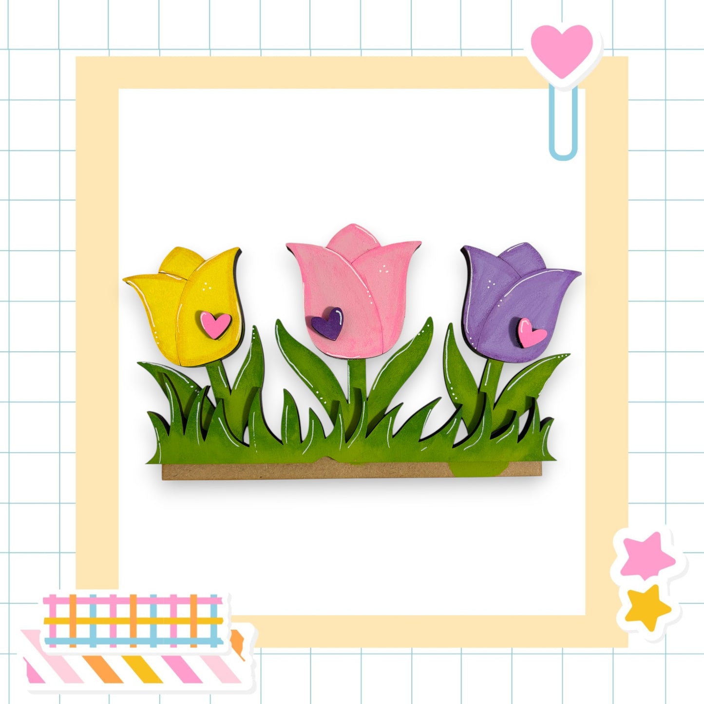 A collage of three colorful tulips in a frame, with a heart and a star decoration on the right side.
