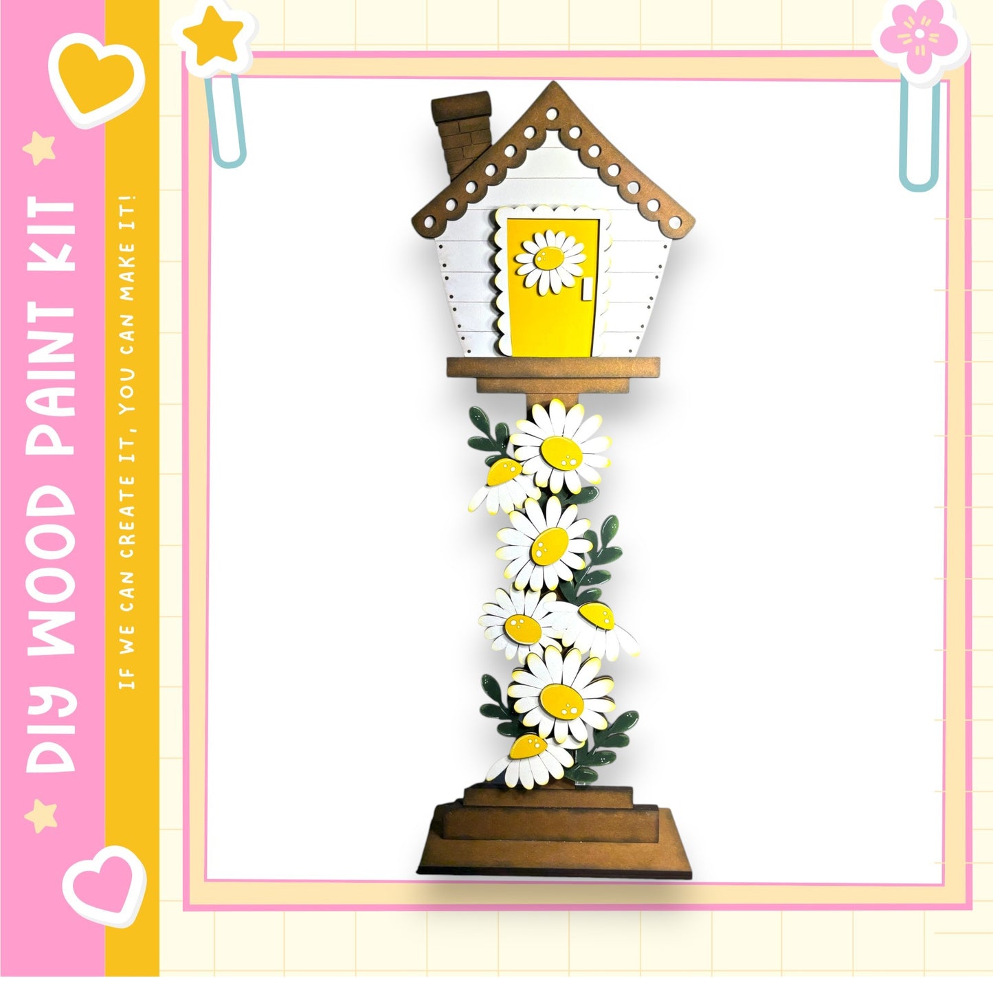 a wooden house-shaped object adorned with white and yellow flowers, creating a charming and whimsical appearance.