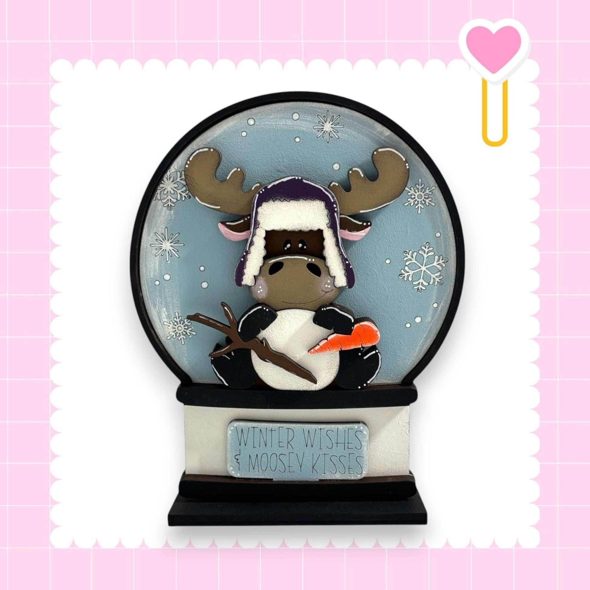 a snow globe with a moose wearing a hat