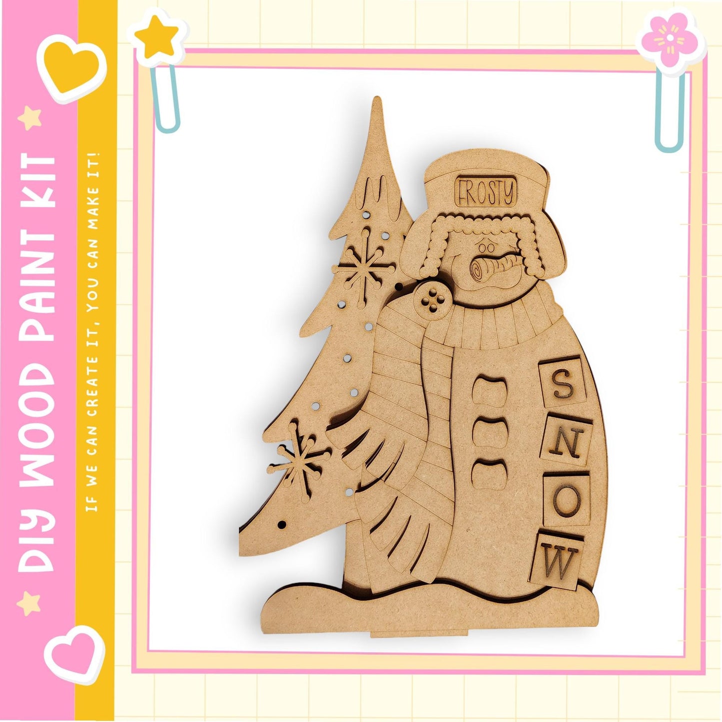 A wooden snowman kit with a snowman figure and a tree, set against a pink and yellow background with decorative elements.