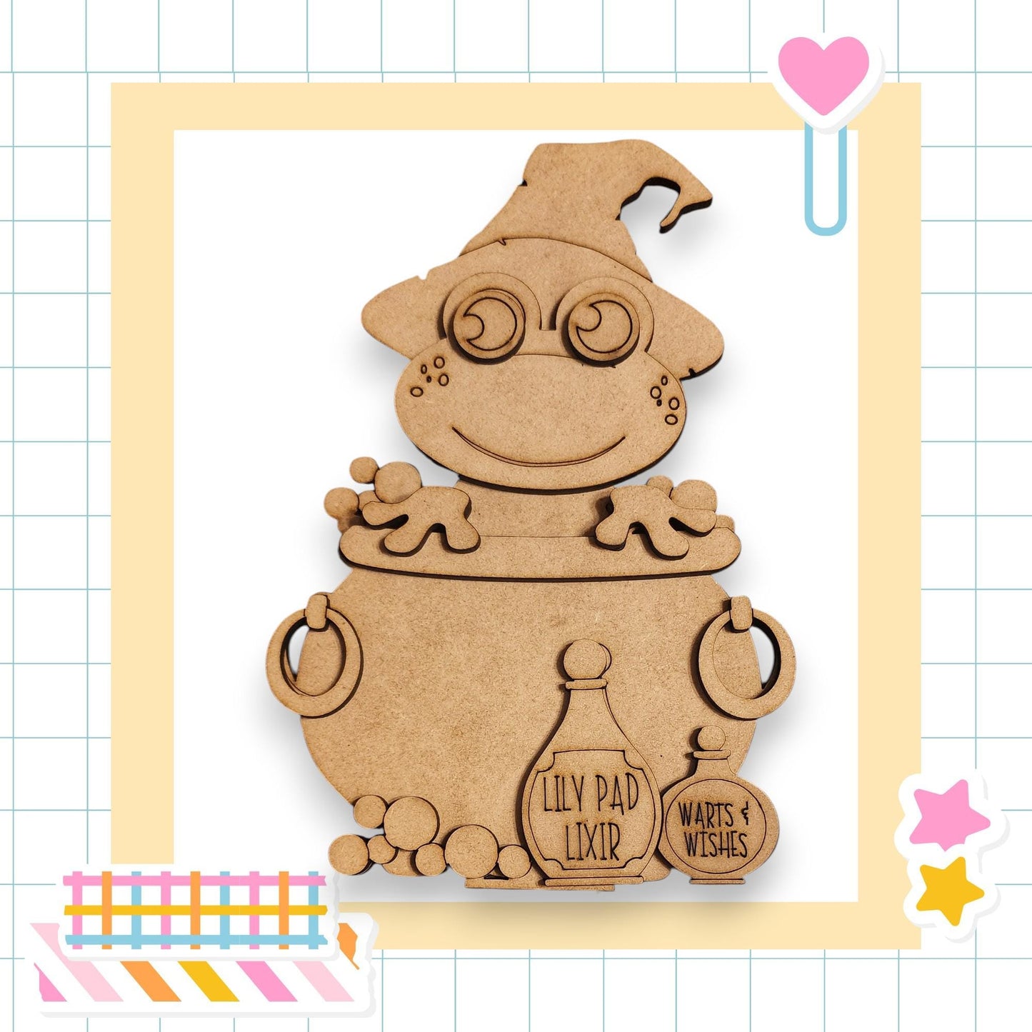 A wooden figure of a smiling, cartoonish character wearing a hat and glasses, sitting in a cauldron and holding a bottle labeled "Lily Pad Lixer".