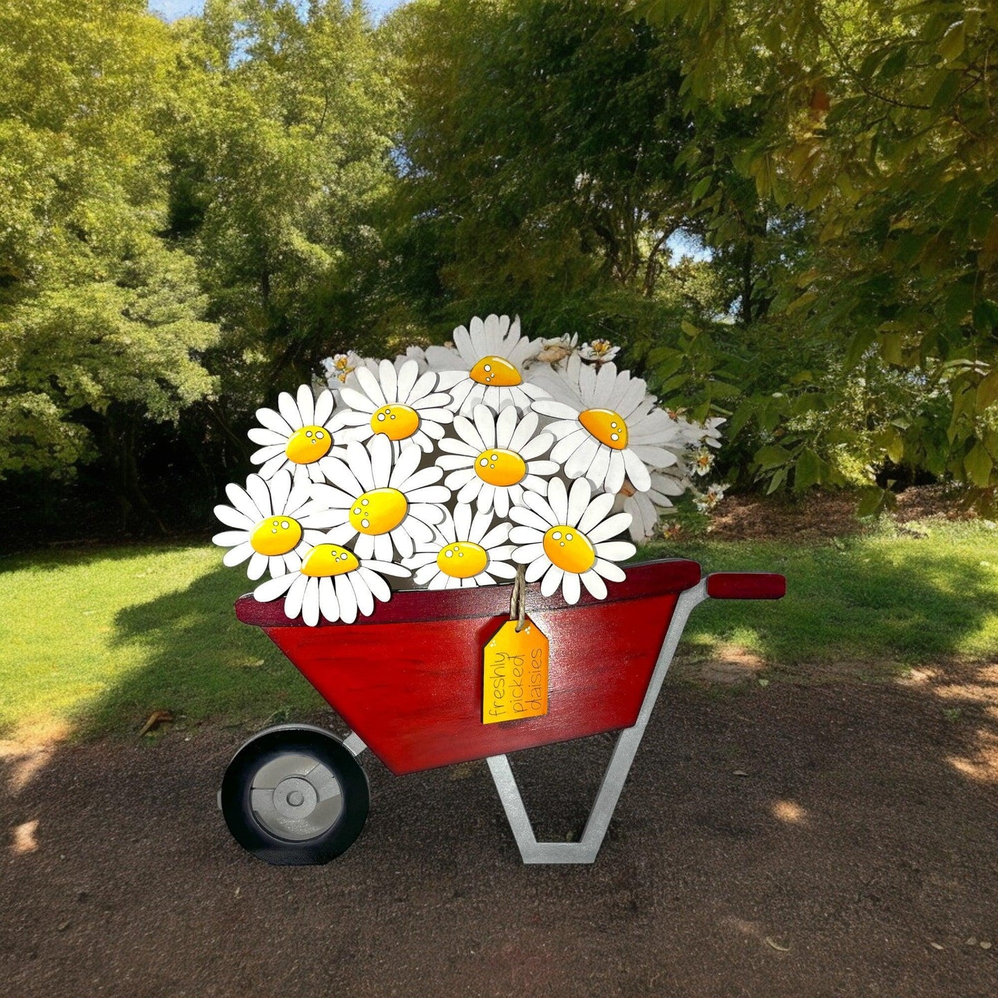 a red wheelbarrow with daisies in it