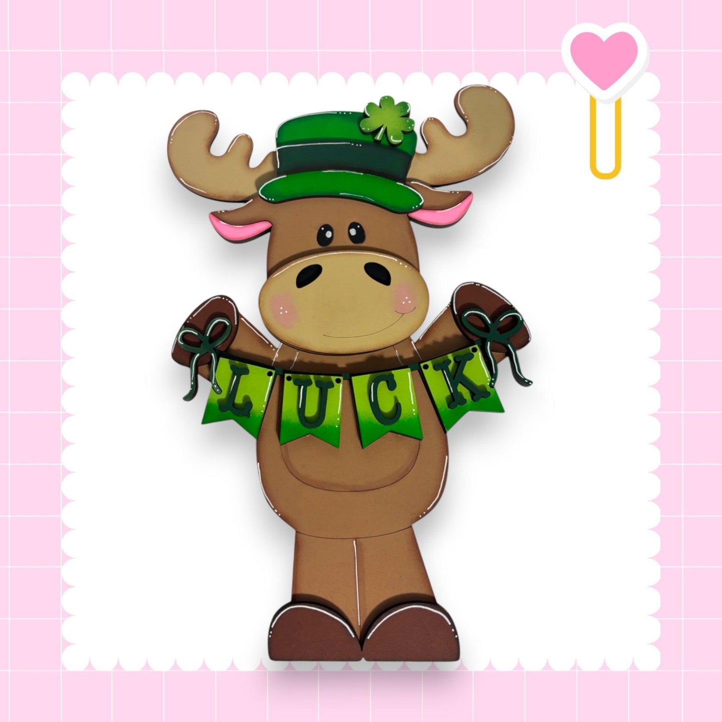 a paper cut out of a moose wearing a green hat