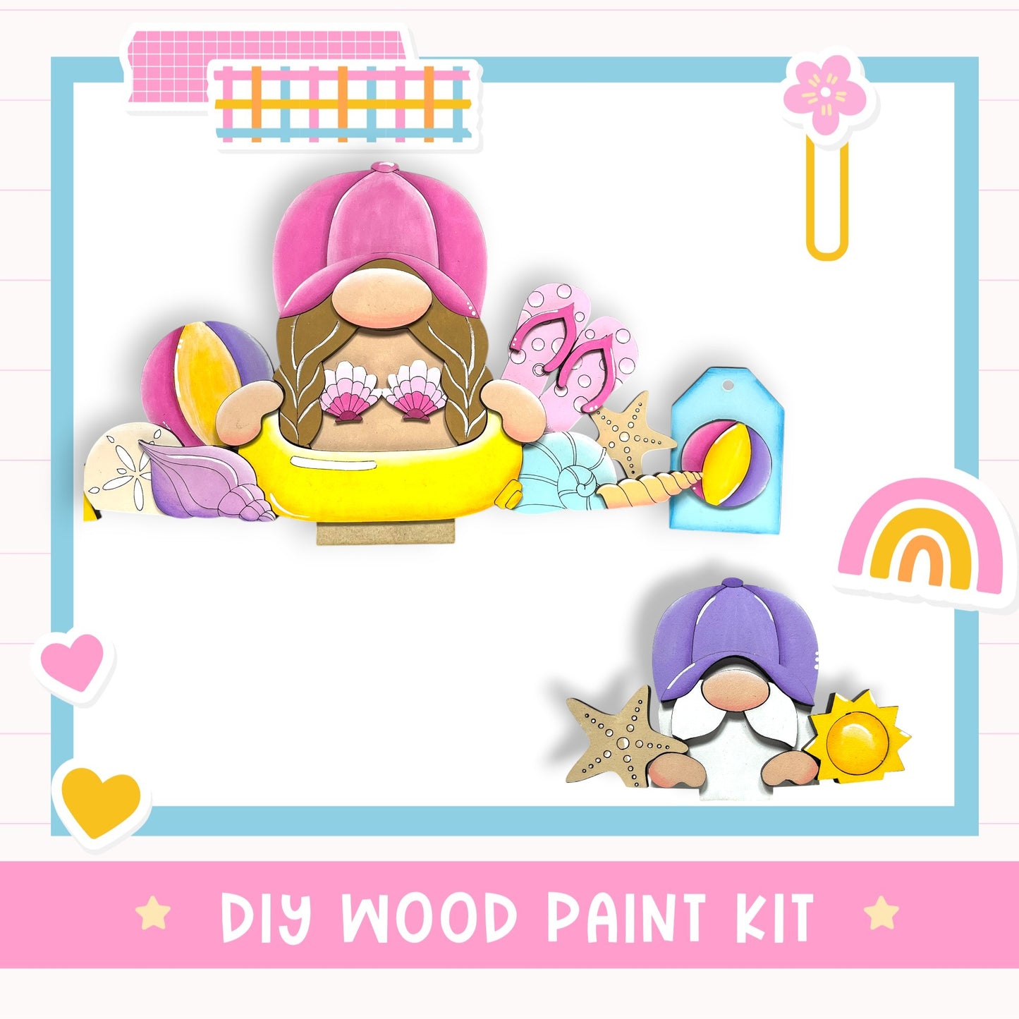 The image is a colorful and whimsical DIY wood paint kit featuring two gnome-like figures, one wearing a pink hat and the other wearing a purple hat, surrounded by various beach-themed objects such as a yellow inflatable tube, a pink and purple seashell, and a blue and yellow starfish.