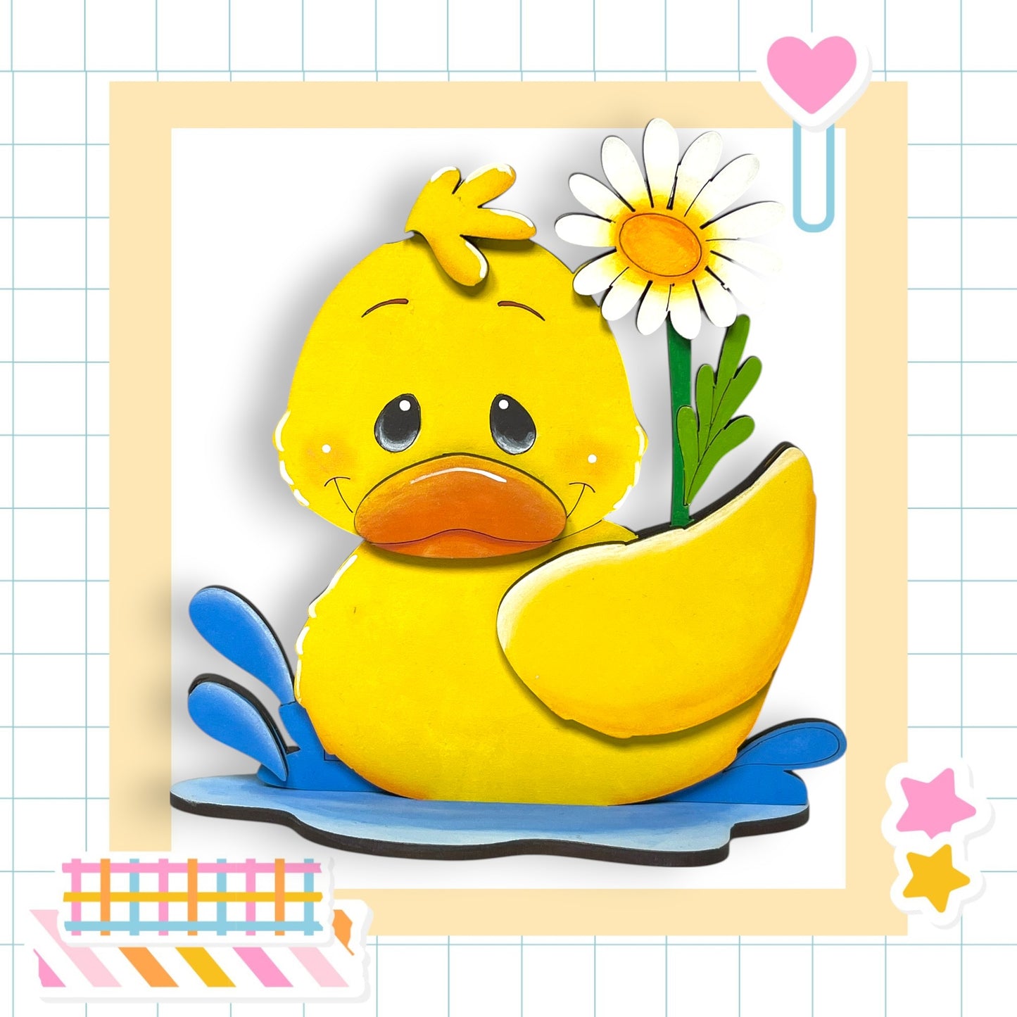 A yellow duck sitting in a puddle, with a white flower and a pink heart decoration nearby.
