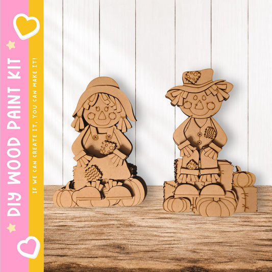 two wooden figurines, one standing and one sitting, placed on a wooden surface against a white background.