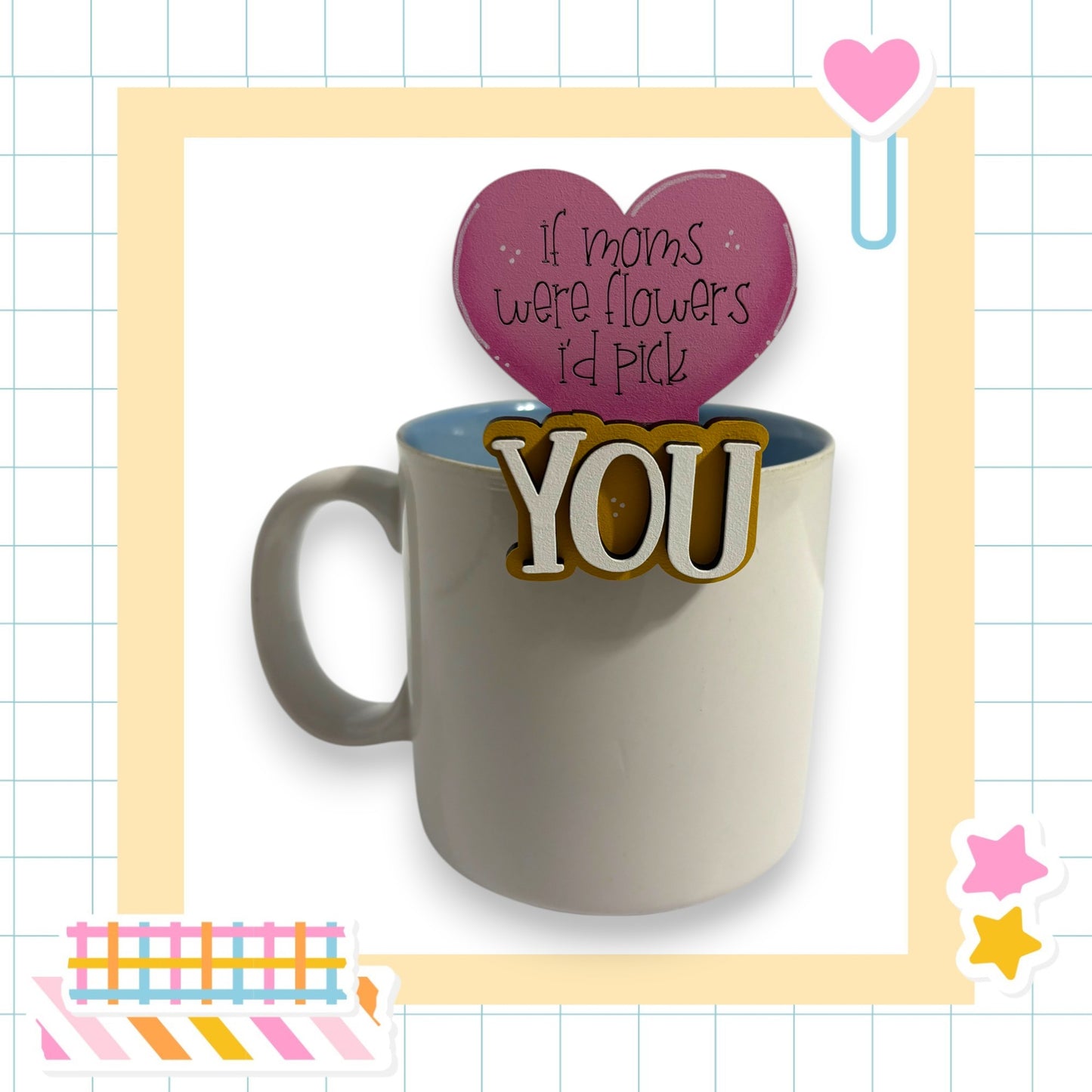 a mug with a heart-shaped sticker on it, and there is a heart-shaped sticker on top of the mug.