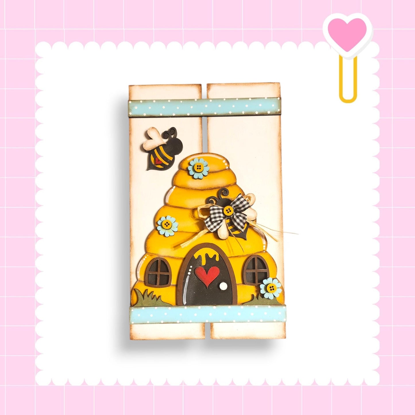 a picture of a yellow house with a bee on it