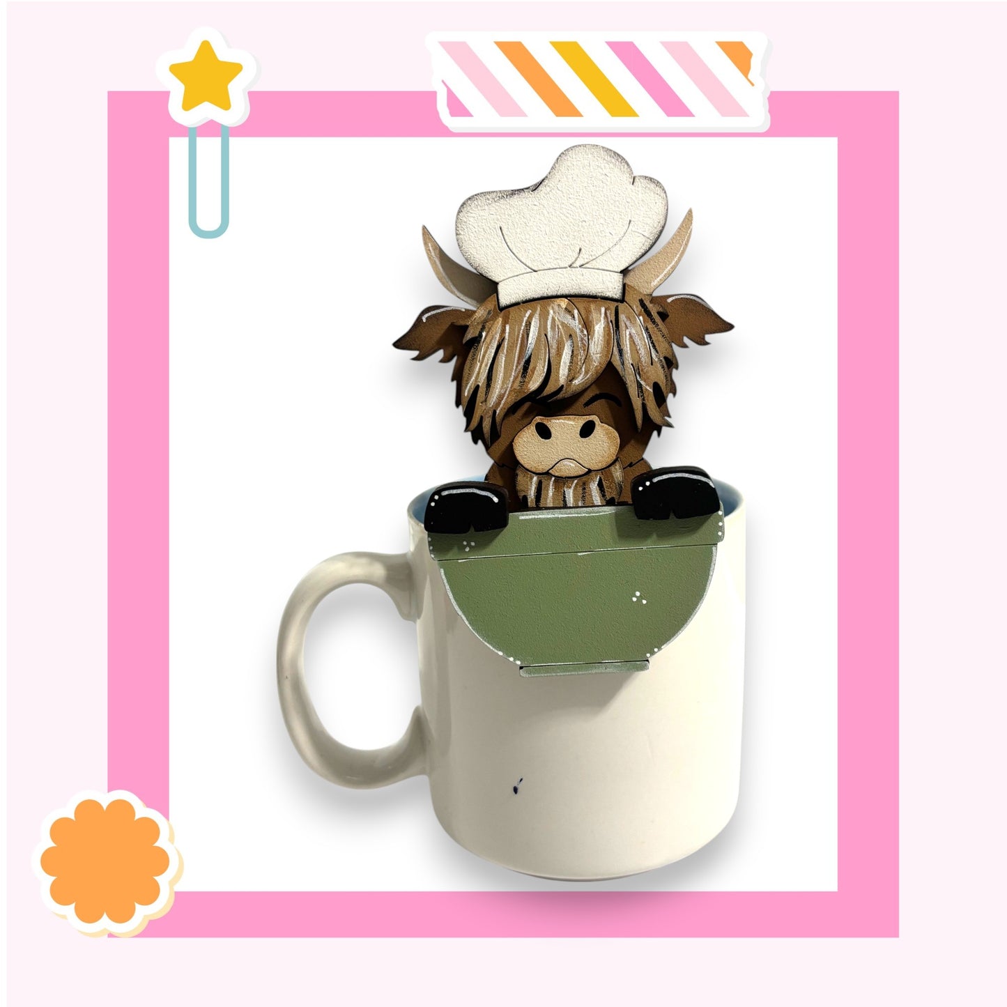A cartoon cow wearing a chef's hat is sitting inside a white mug, which is placed on a pink background.