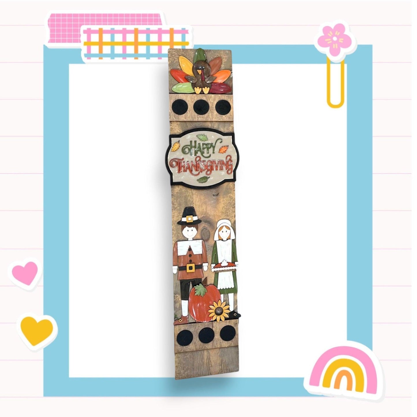 a picture of a tall wooden tower with a happy thanksgiving sign on it