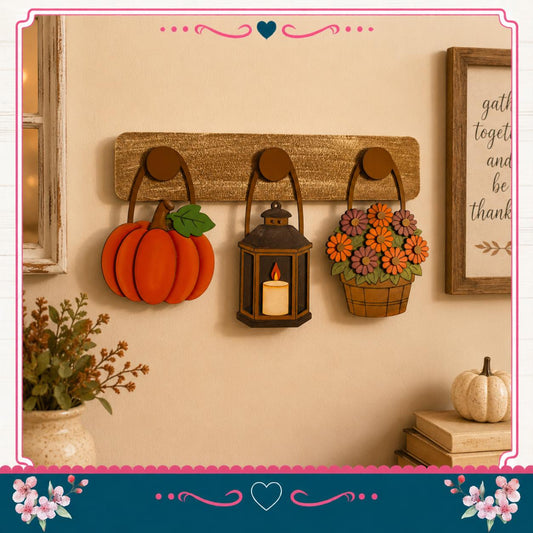 a wall decorated with three wooden wall hangings: a pumpkin, a lantern, and a basket of flowers. The wall is also adorned with a framed quote and a vase of flowers, creating a cozy and festive atmosphere.