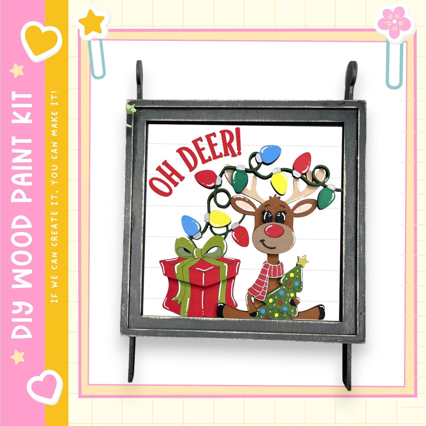 A framed illustration of a reindeer holding a gift box with Christmas lights, accompanied by the text "OH DEER!"