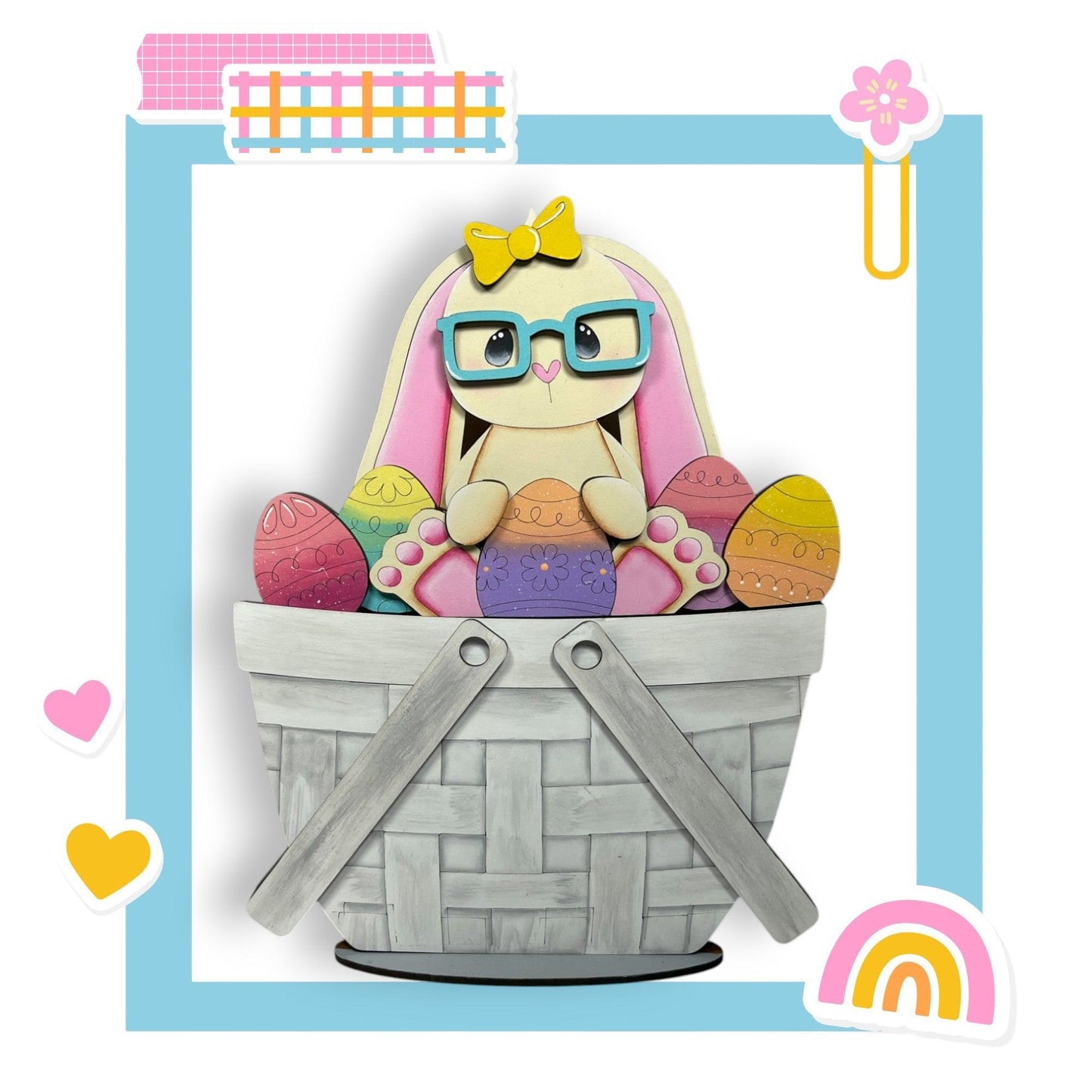 a paper cut of a bunny sitting in a basket of eggs