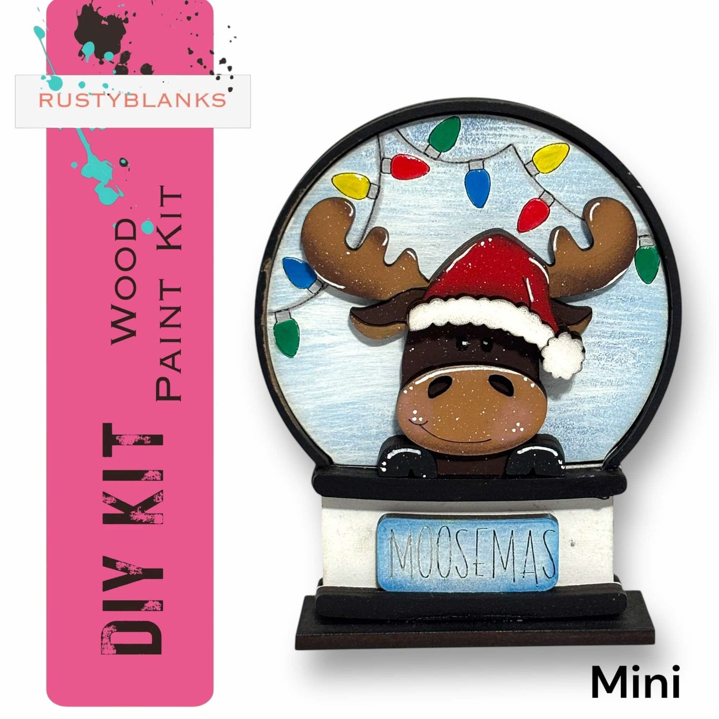 a DIY kit for a Moosemas snow globe, which includes a wooden frame and a moose figurine wearing a Santa hat.
