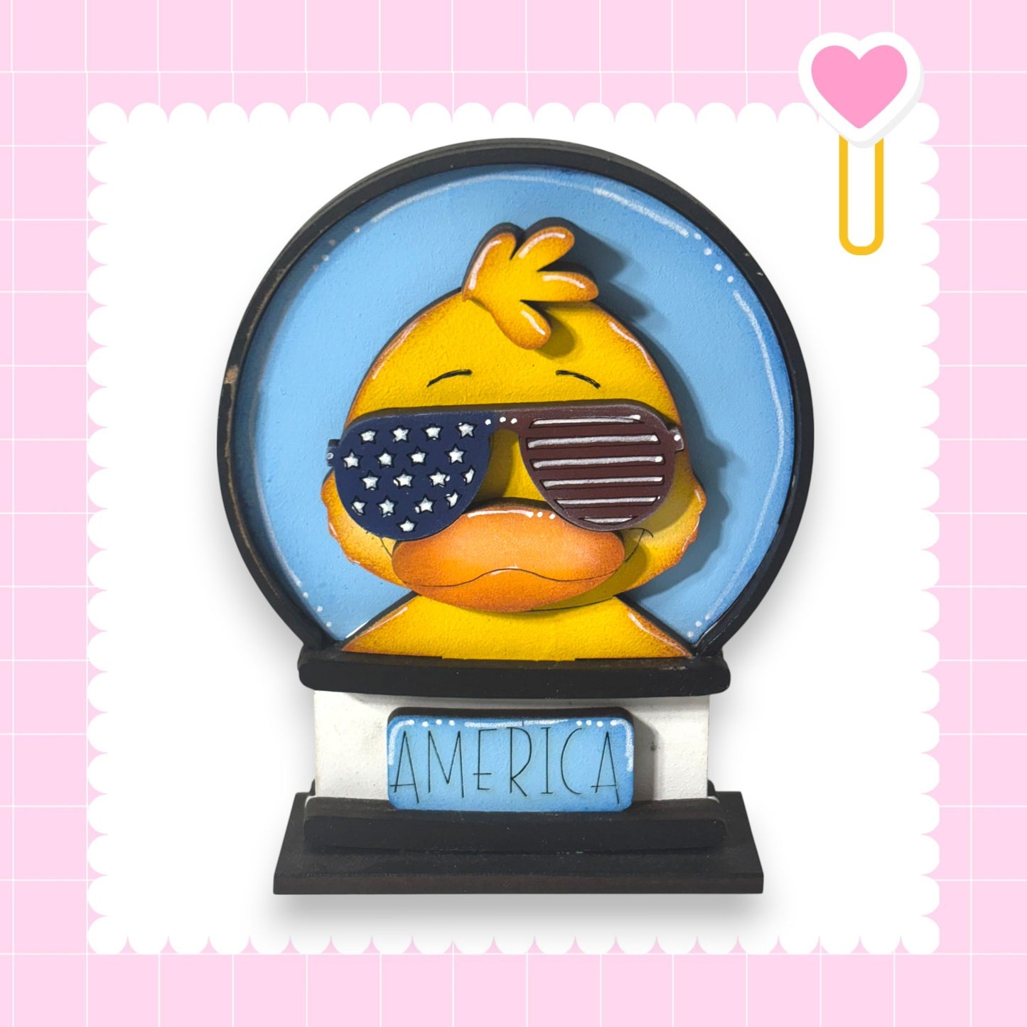 A yellow duck wearing sunglasses and the word "AMERICA" on a black base.