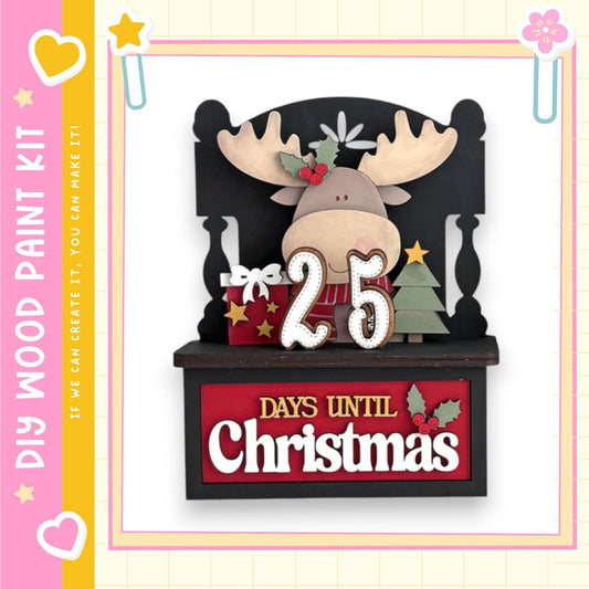 A wooden Christmas decoration kit with a moose head and other holiday-themed elements. The kit includes a sign that says "25 DAYS UNTIL CHRISTMAS".