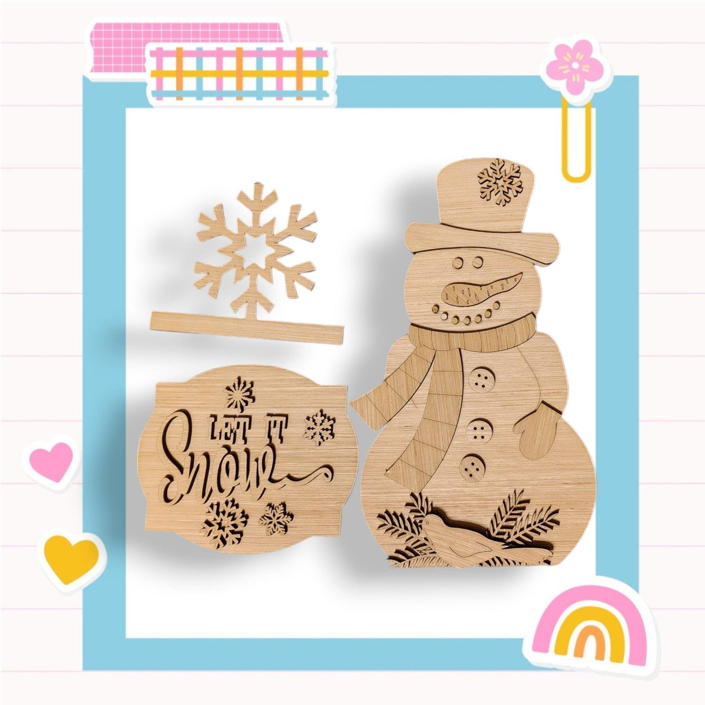 a wooden cutout of a snowman and a rainbow