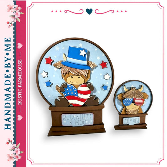 two snow globes, each containing a cartoon character wearing patriotic attire. The character in the larger snow globe is wearing a hat and holding an American flag, while the character in the smaller snow globe is wearing sunglasses and holding a moo. The snow globes are set against a blue background with stars and red and white stripes.