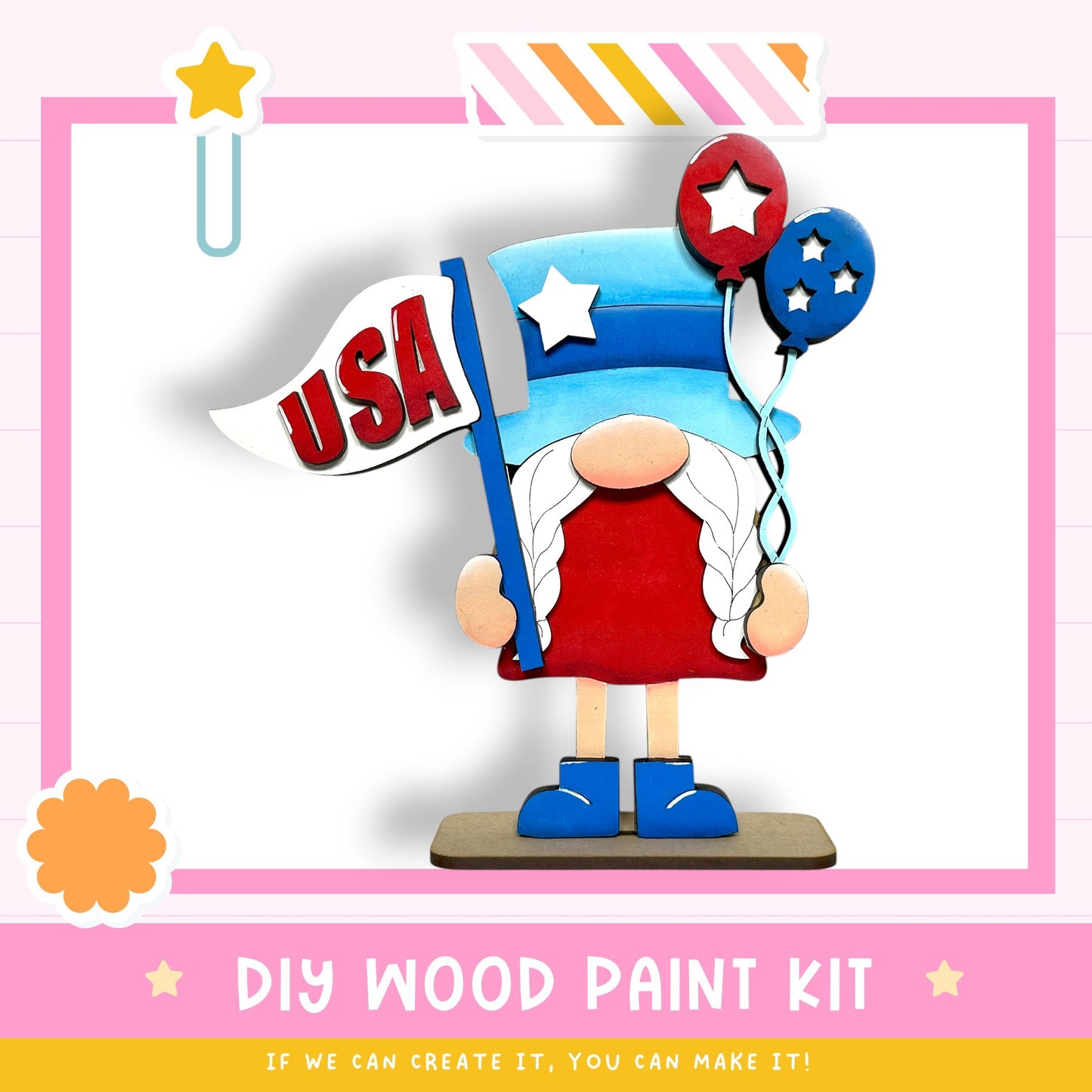 a wooden gnome figure holding a flag with the word "USA" written on it, along with two red and blue balloons. The image also includes a DIY wood paint kit and a message encouraging creativity.