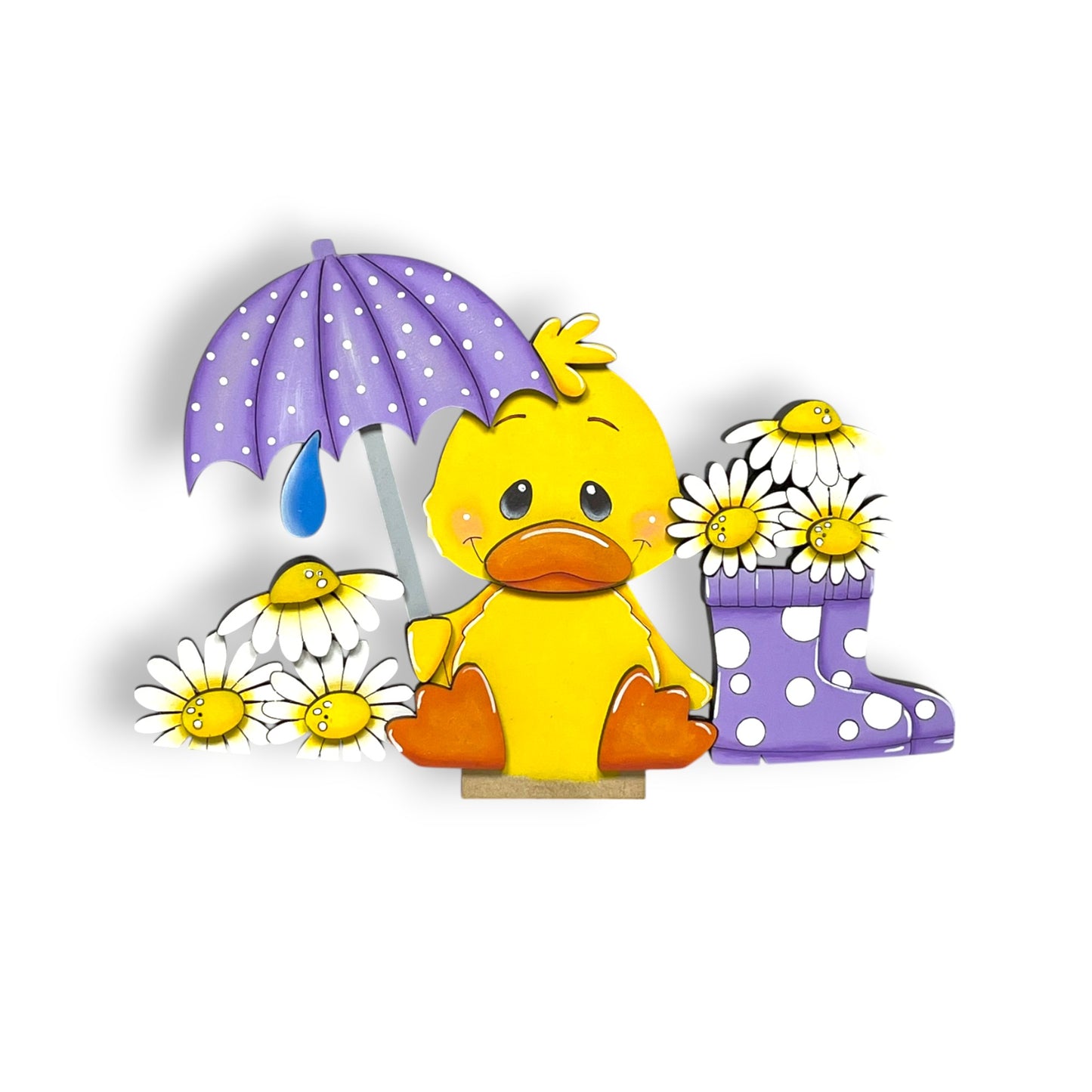 A yellow duck sitting on a wooden base, holding a purple umbrella and surrounded by white daisies and a purple rain boot.