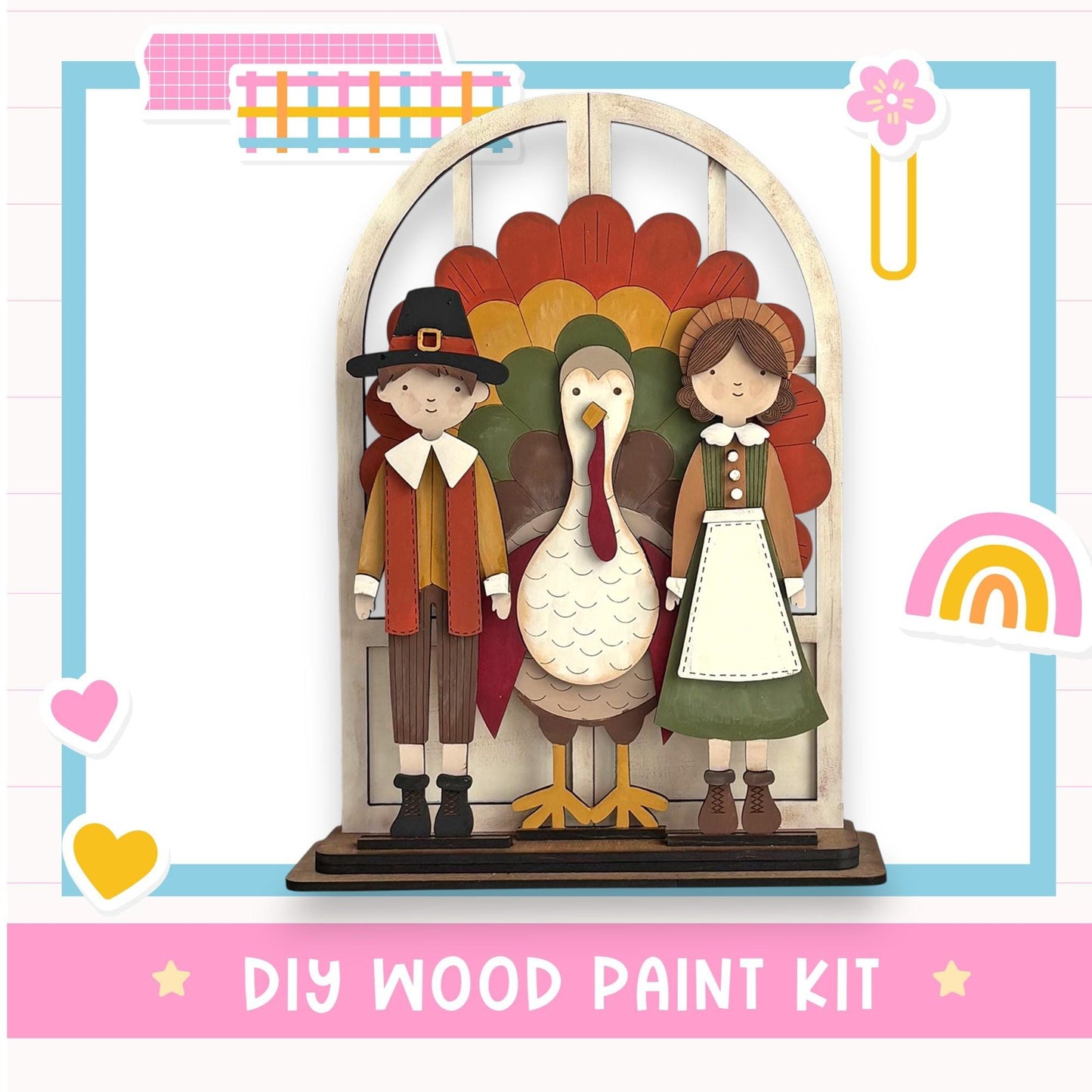 A DIY wood paint kit featuring a wooden frame with a turkey, a boy in a red and brown outfit, and a girl in a green dress, set against a colorful background.