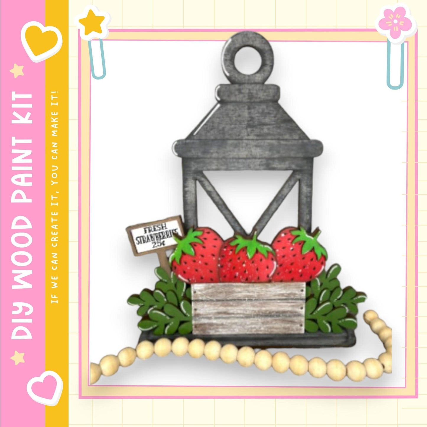 A wooden lantern with a sign that reads "Fresh Strawberries" is displayed against a white background, surrounded by a beaded garland.