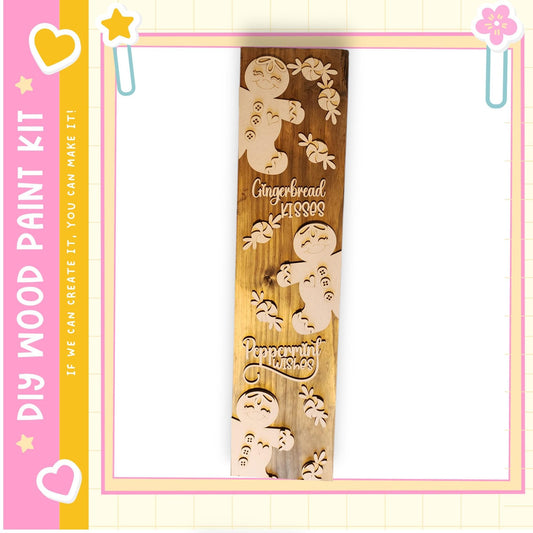 A wooden sign with a decorative design featuring gingerbread men and peppermint leaves.