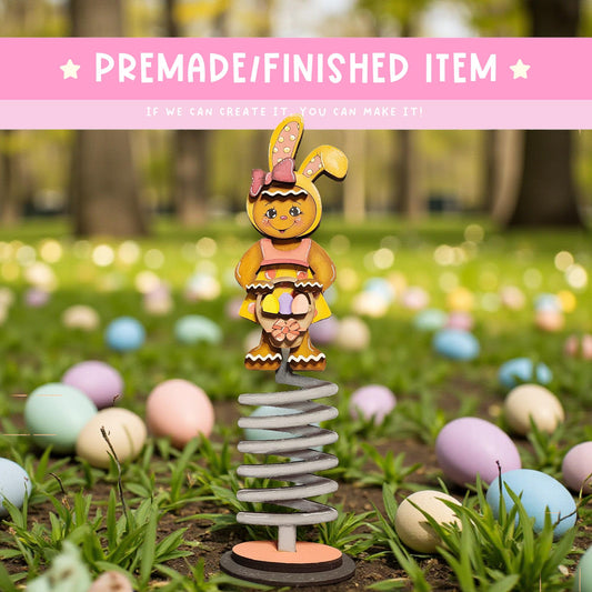 A whimsical Easter-themed scene featuring a toy rabbit on a spring-like structure, surrounded by colorful Easter eggs in a grassy field.