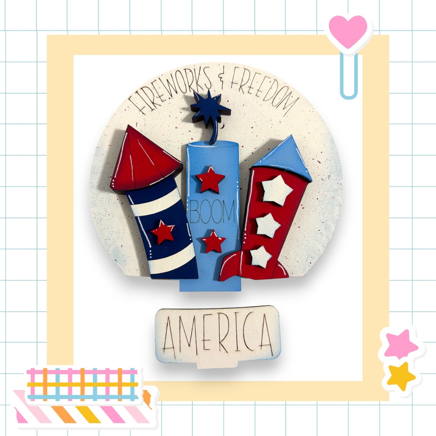 The image is a collage featuring a central image of a fireworks display with the words "FIREWORKS & FREEDOM" written above it. The fireworks are depicted in red, white, and blue colors, and the word "AMERICA" is written below the fireworks. The collage includes various colorful stickers and shapes surrounding the central image.