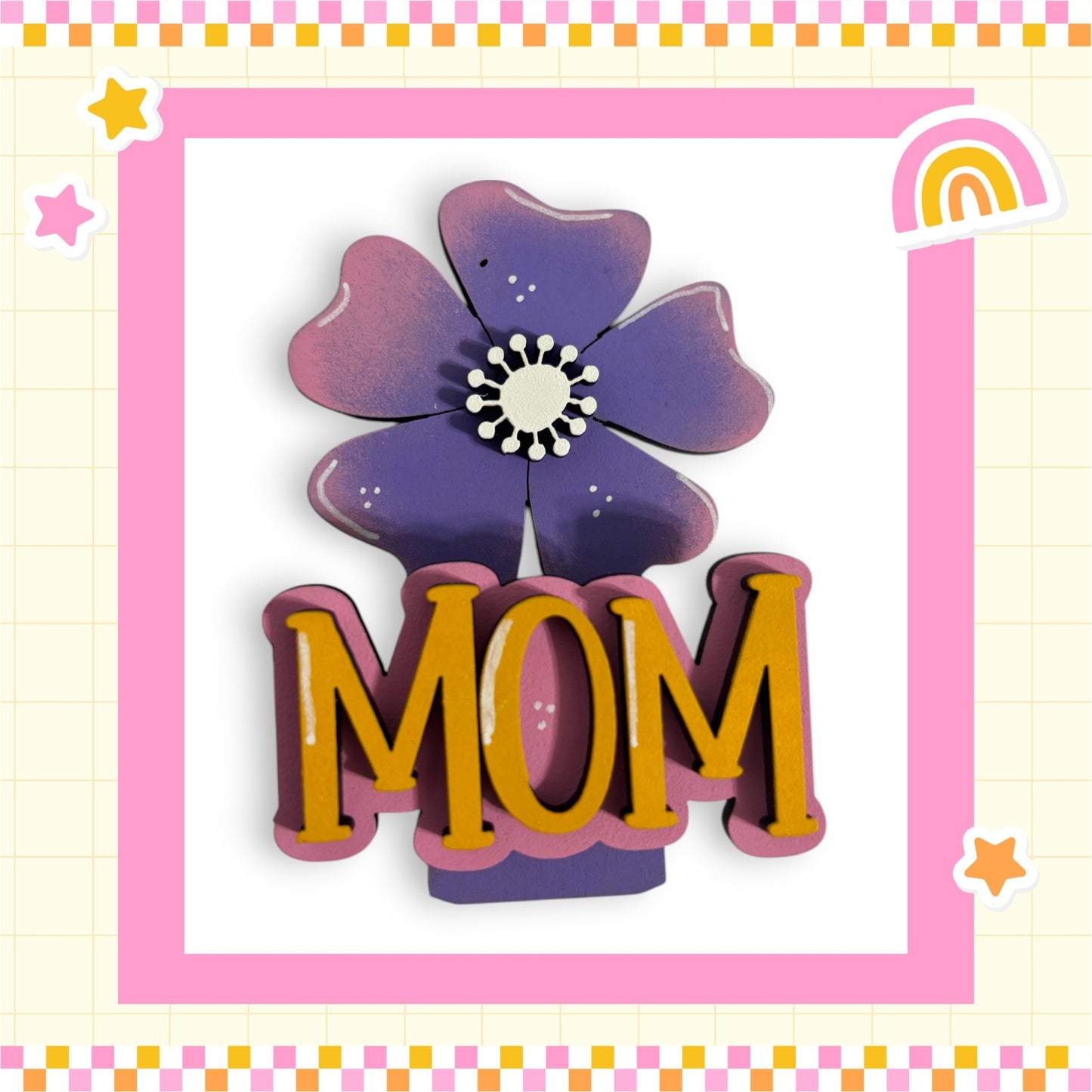 A decorative floral design with the word "MOM" prominently displayed in the center, surrounded by a pink and yellow border.