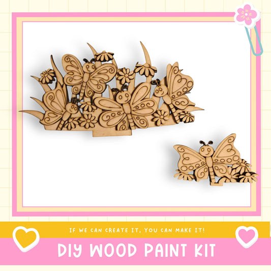 The image is a DIY wood paint kit advertisement, featuring a wooden butterfly and flower design. The text on the image encourages viewers to "If we can create it, you can make it!" and includes a heart symbol and a pink and yellow color scheme.