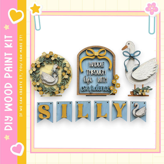 The image is a colorful and whimsical collage featuring various decorative elements, including a wooden swan, a banner with the word "Silly", and a heart-shaped sticker.