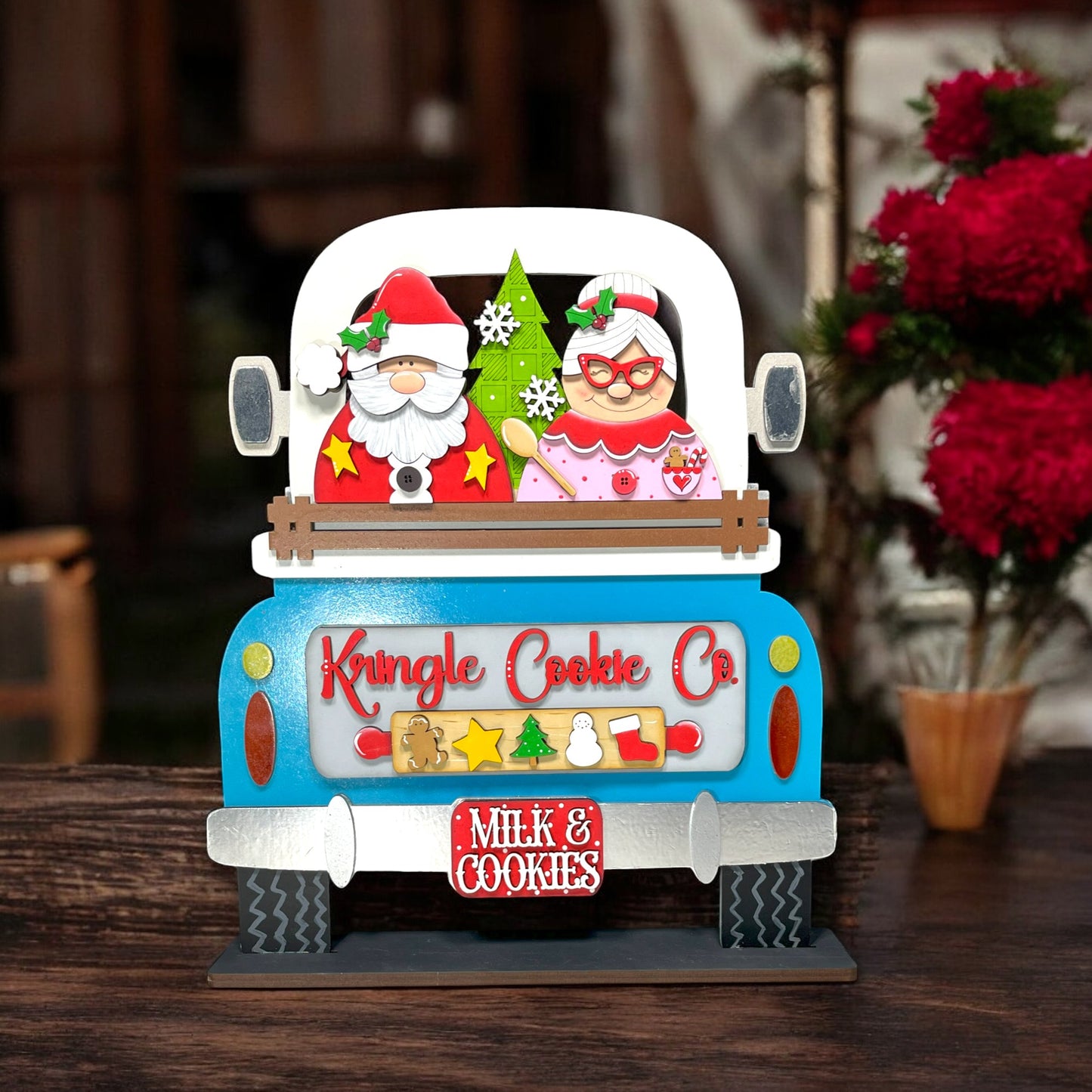 a blue and white truck with a santa clause on it