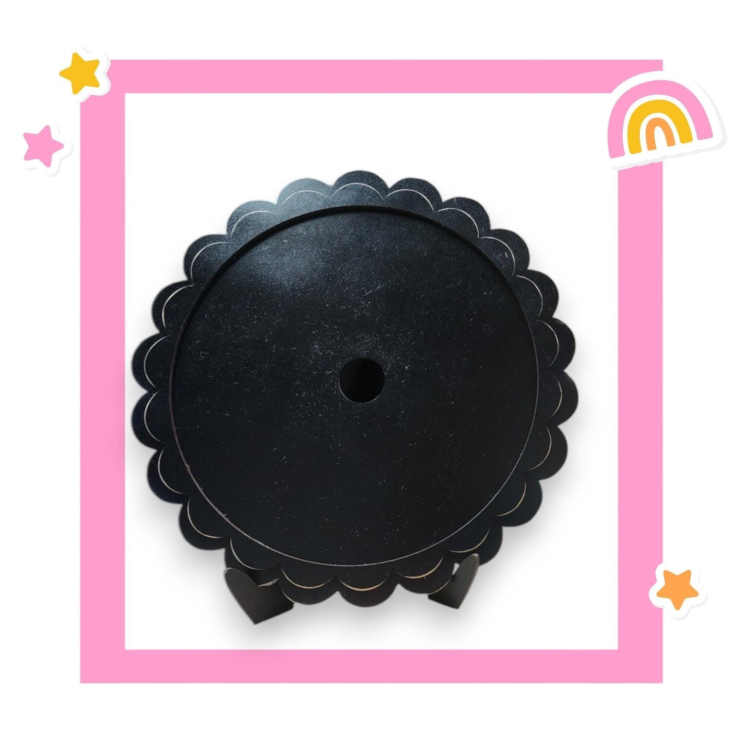 a picture of a round black object with a rainbow in the background