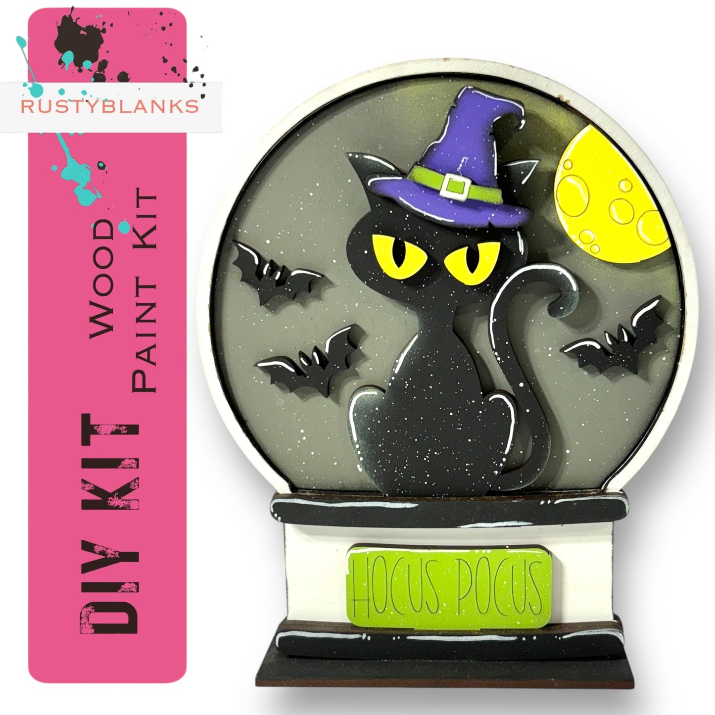 A black cat wearing a purple witch's hat is depicted inside a wooden snow globe, with bats flying around it. The snow globe is labeled as a "DIY KIT" and "Hocus Pocus" kit, suggesting it is a kit for creating a Halloween-themed decoration.