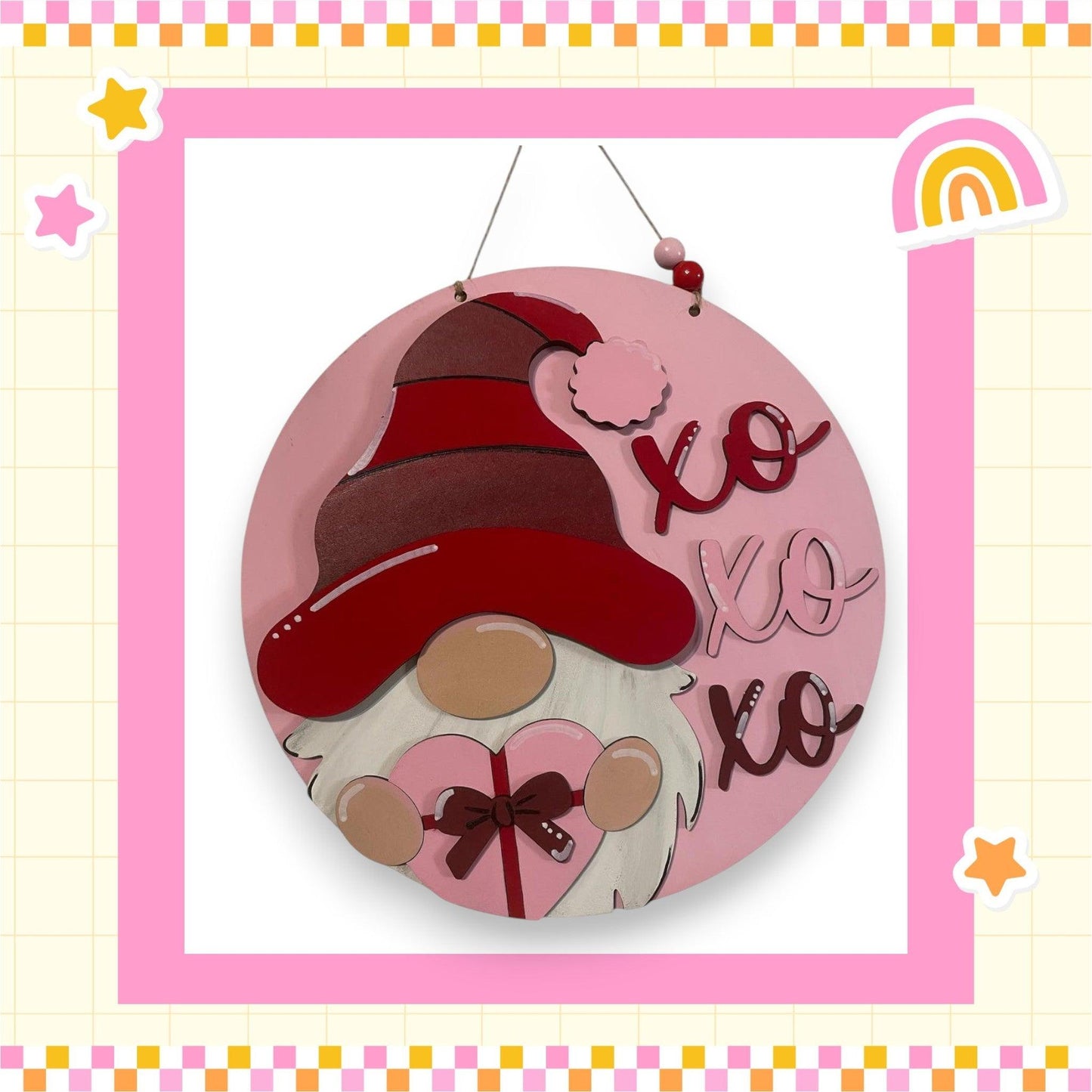 a picture of a pink plaque with a gnome on it