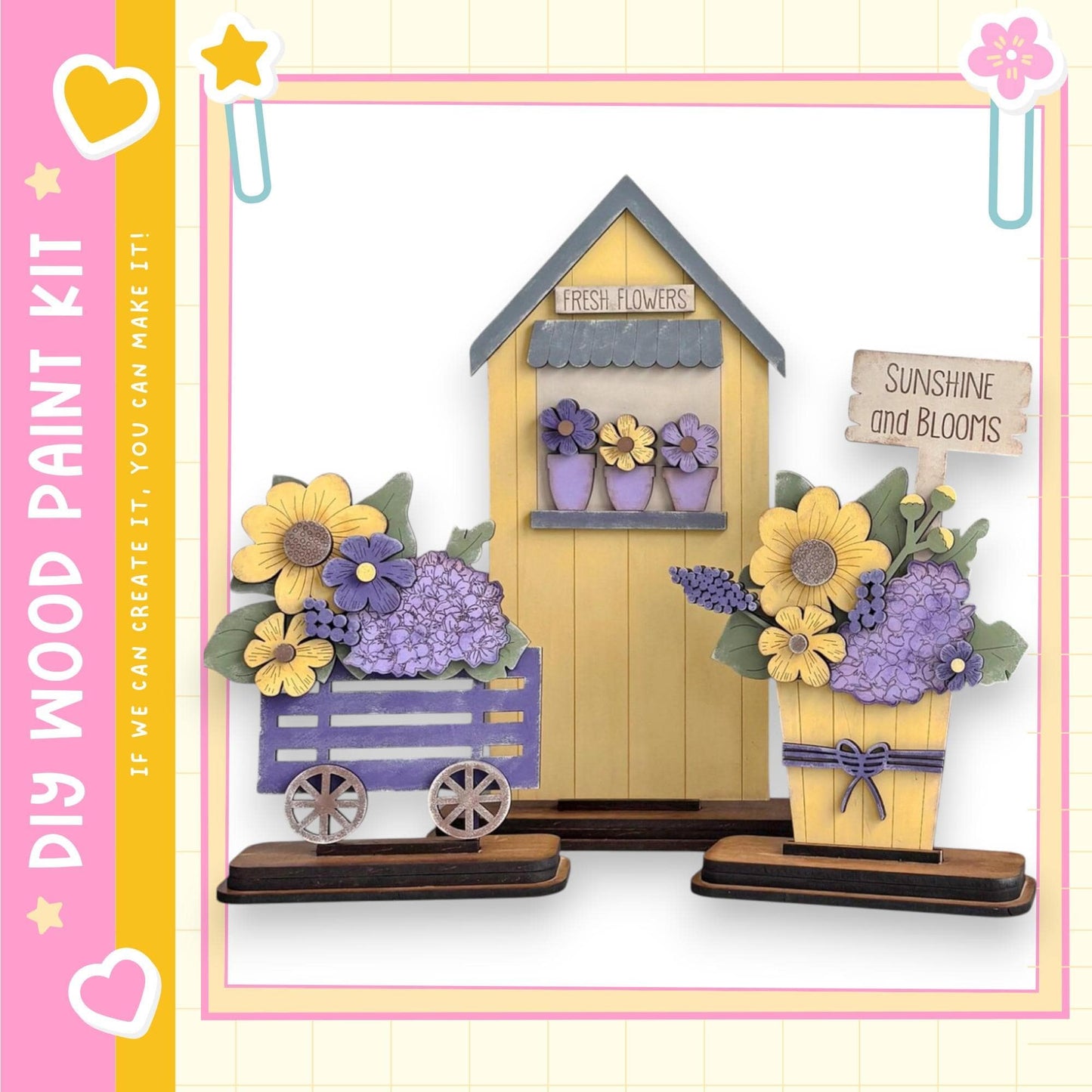 a wooden paint kit for creating a flower display, including a small wooden house and two wooden flower planters. The kit appears to be designed for creating a charming and colorful flower arrangement.