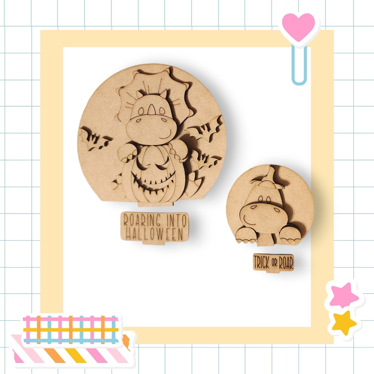 two wooden cutouts of cartoon-like creatures, likely representing a hippo and a dragon, set against a grid background. The cutouts appear to be made of wood and are placed within a frame.