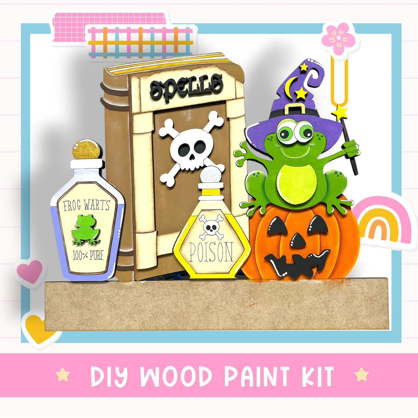 The image is a DIY wood paint kit featuring a frog, a pumpkin, and various Halloween-themed items such as a spell book and a poison bottle.