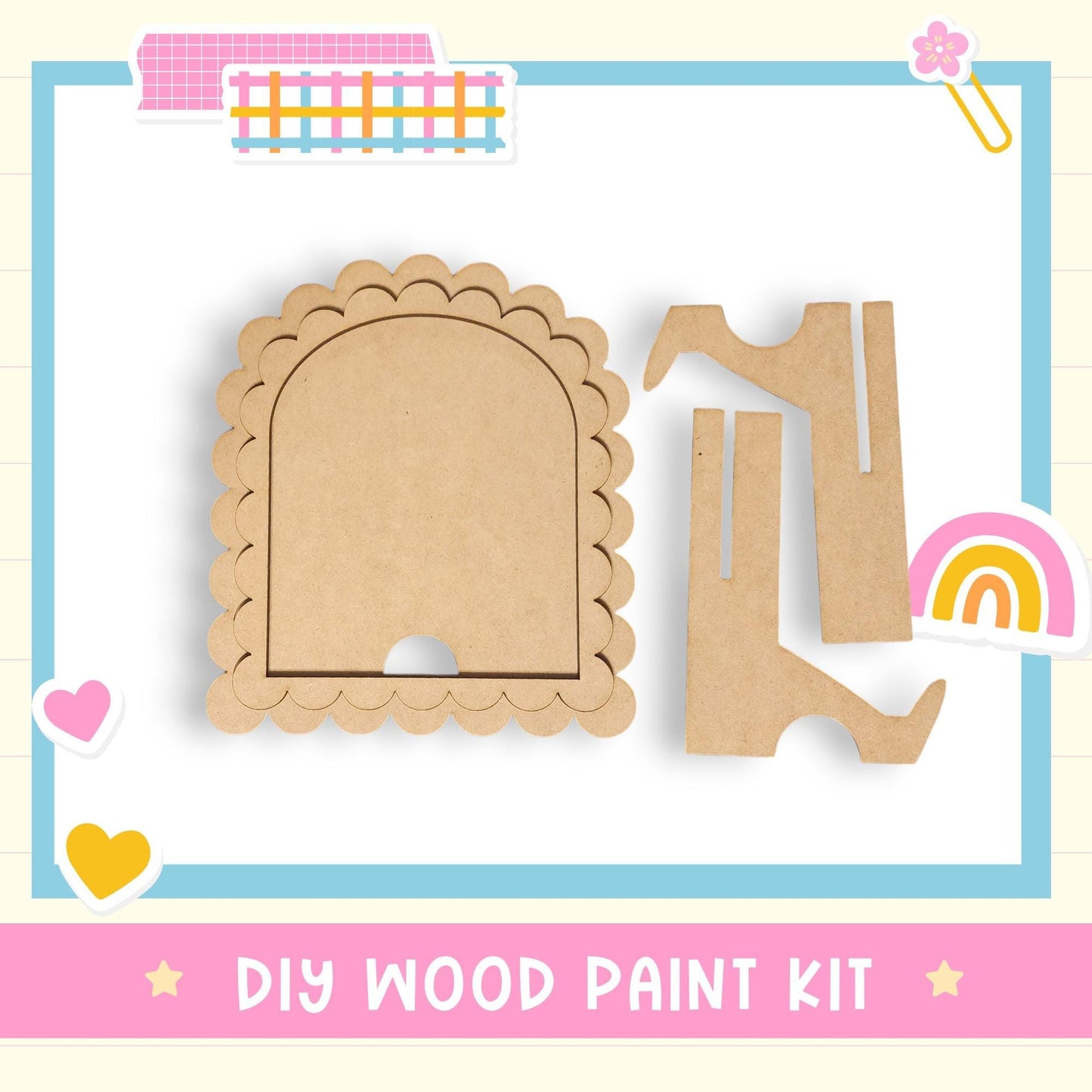 The image is a DIY wood paint kit, featuring a wooden frame with a scalloped edge and two wooden pieces, one of which is a wooden boot. The kit is presented against a light blue background with a pink border.