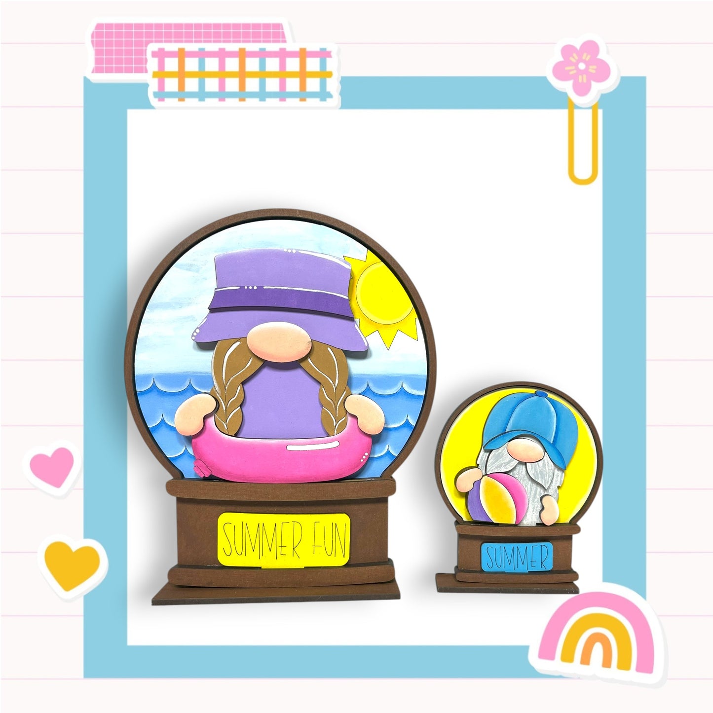 two gnomes, one larger and one smaller, both wearing hats and holding balls, set against a beach scene with a sun and ocean. The larger gnome is wearing a purple hat and the smaller one is wearing a blue hat. The background of the image is a beach scene with a pink and blue umbrella and a pink and blue flower. The phrase "SUMMER FUN" is written on a sign below the larger gnome.