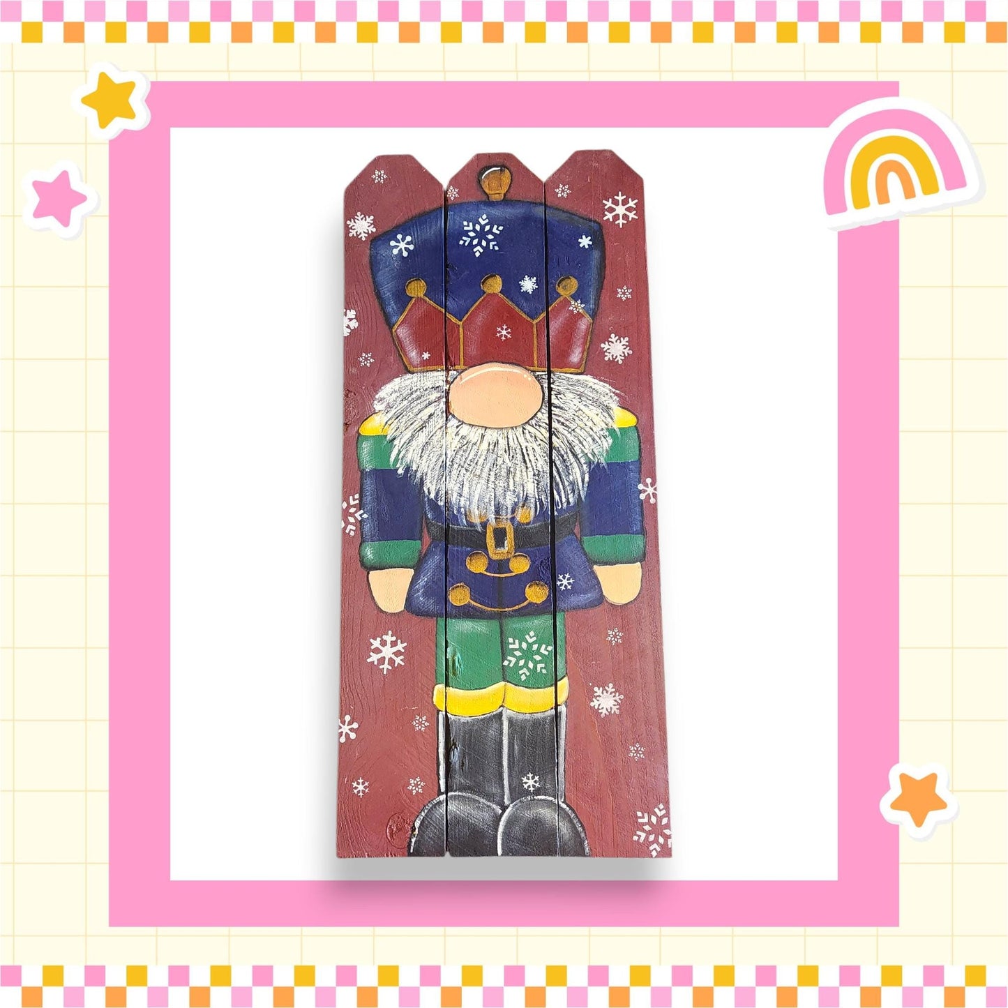 A wooden nutcracker figure with a colorful outfit and a crown, surrounded by snowflakes, is depicted in the image.
