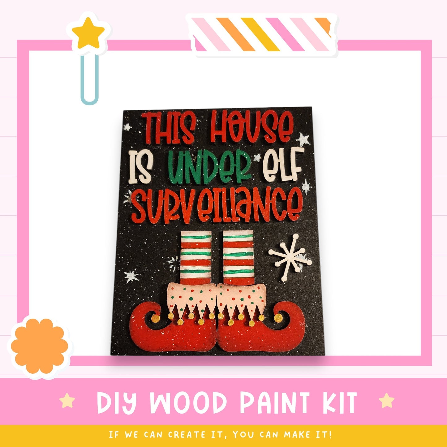 The image is a DIY wood paint kit for creating a house that is under an elf surveillance.