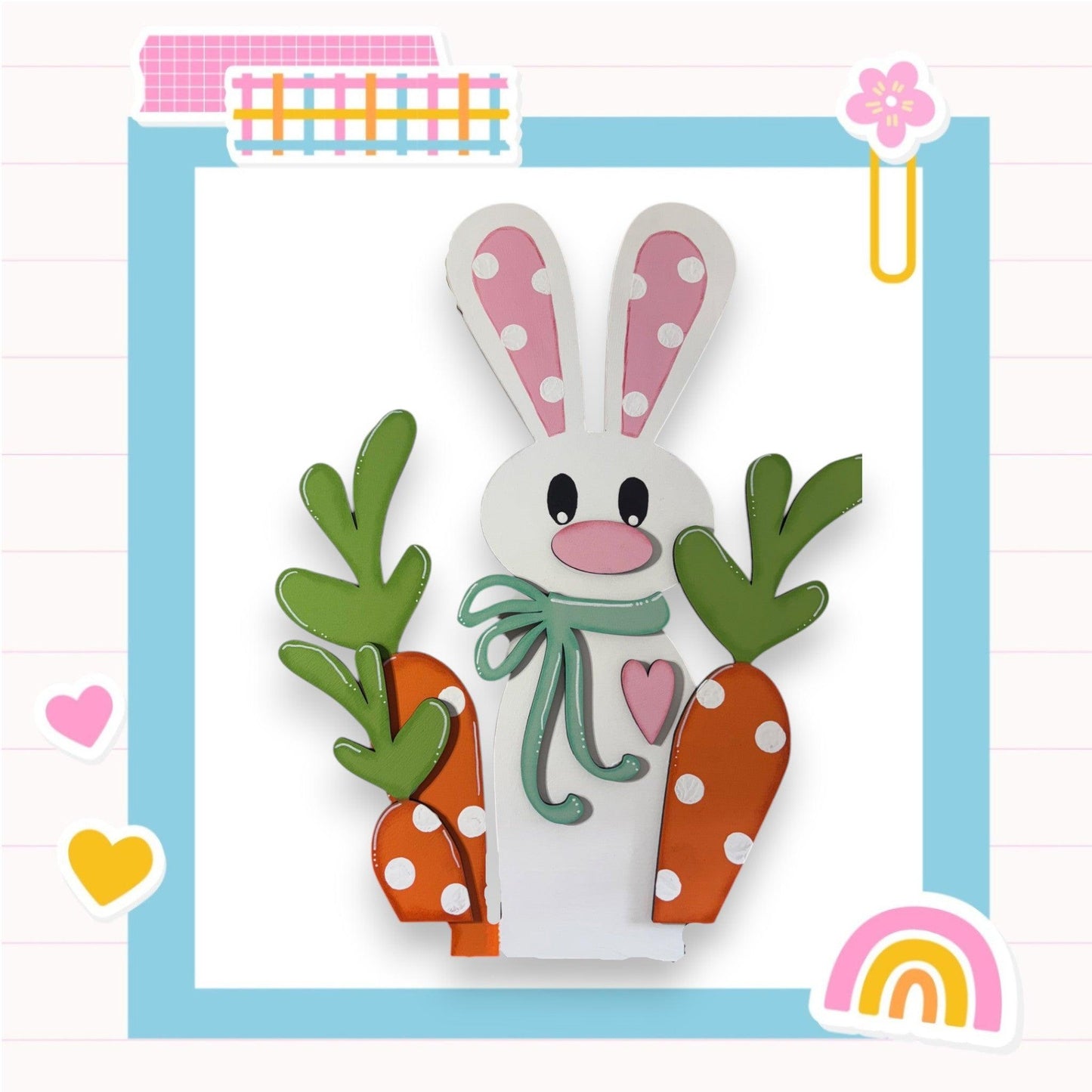 a paper cut of a bunny holding carrots