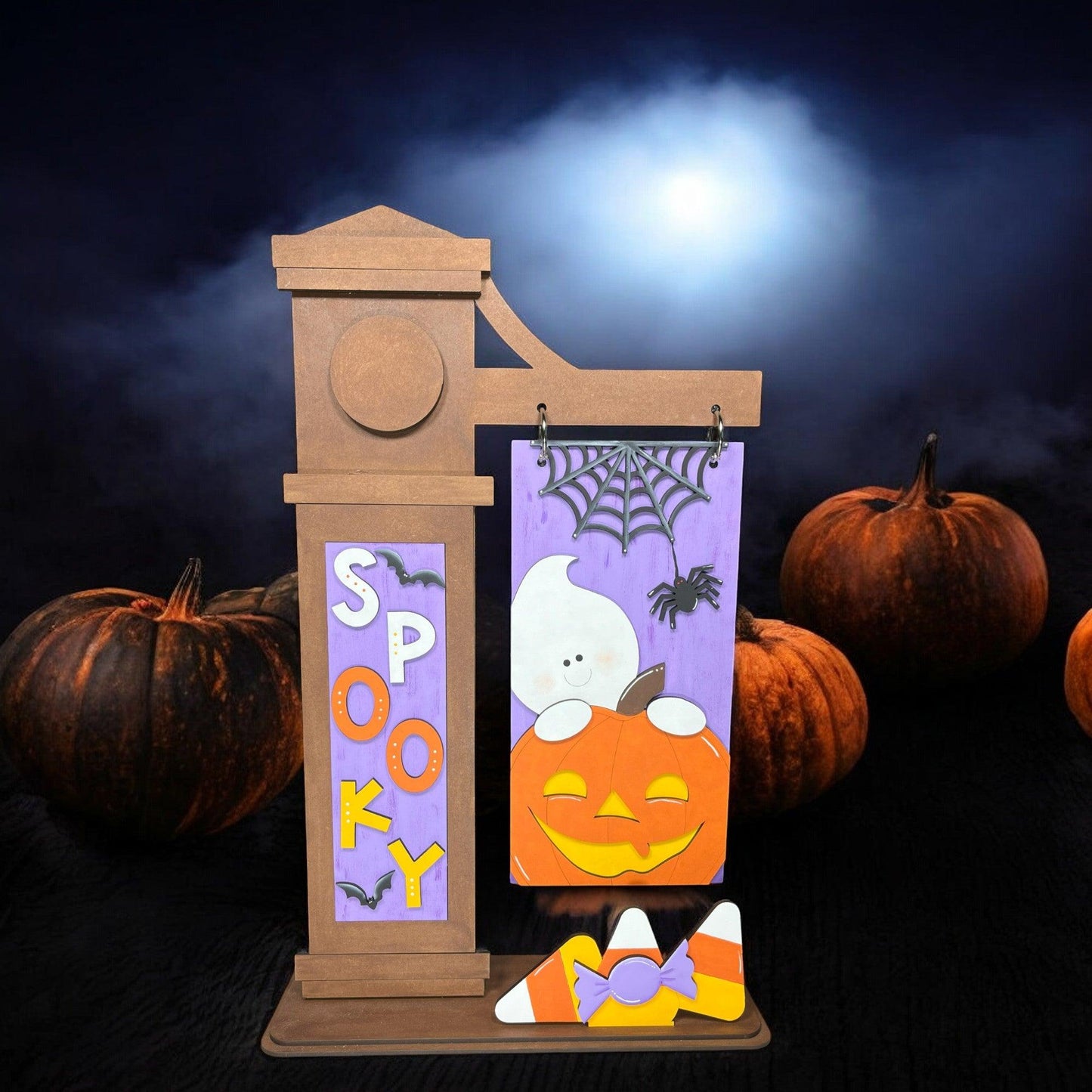 a picture of a halloween decoration with pumpkins in the background
