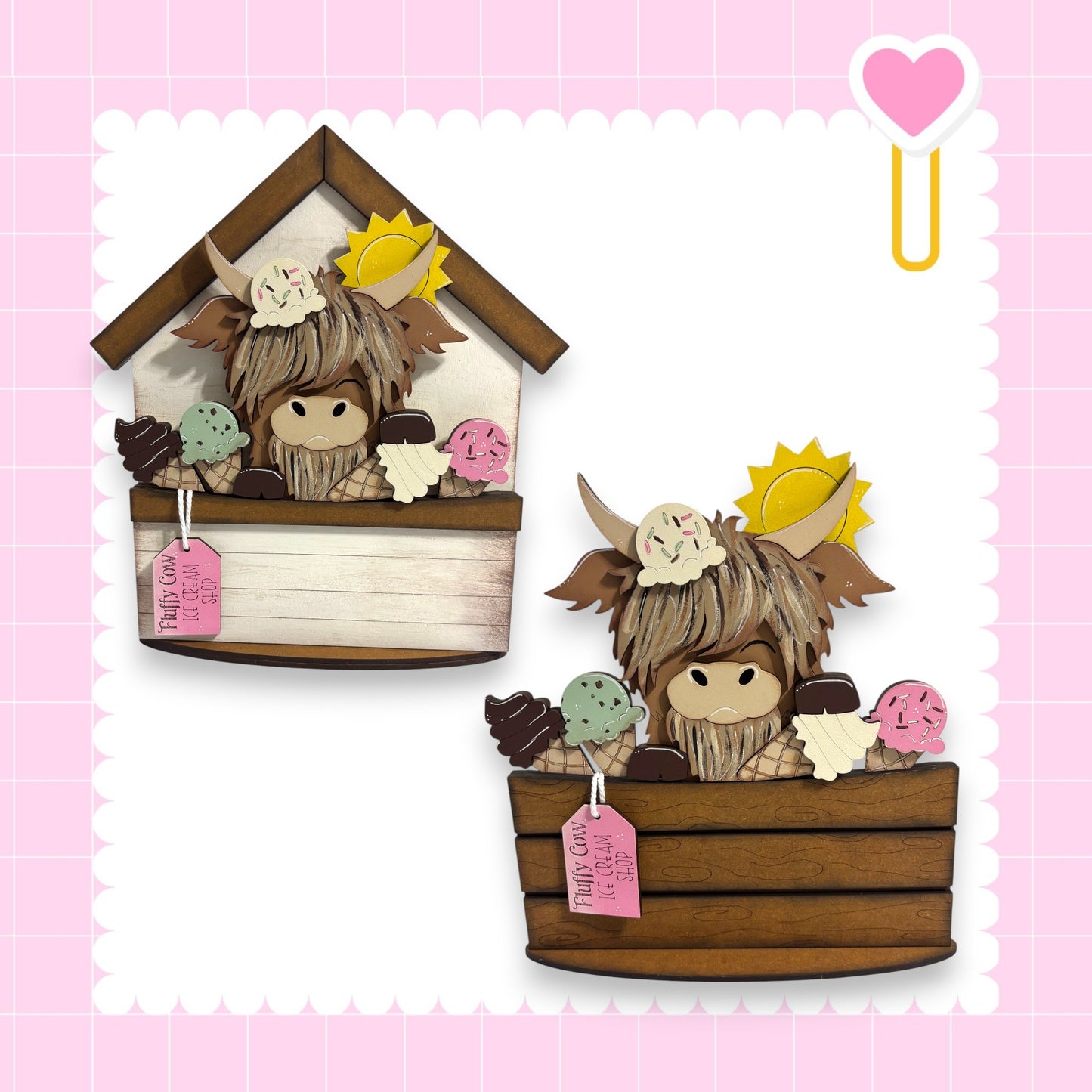 two wooden cutouts of a cow, each holding a basket of ice cream. The cow cutouts are placed on a pink background with a heart shape and a yellow sun.